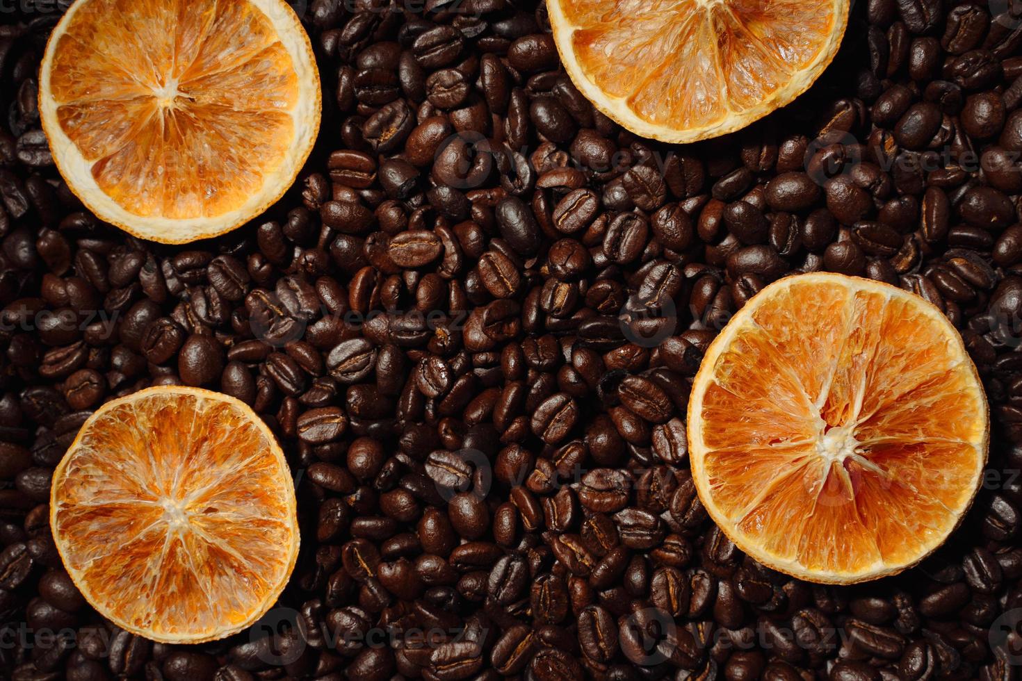 Orange slices on coffee beans photo