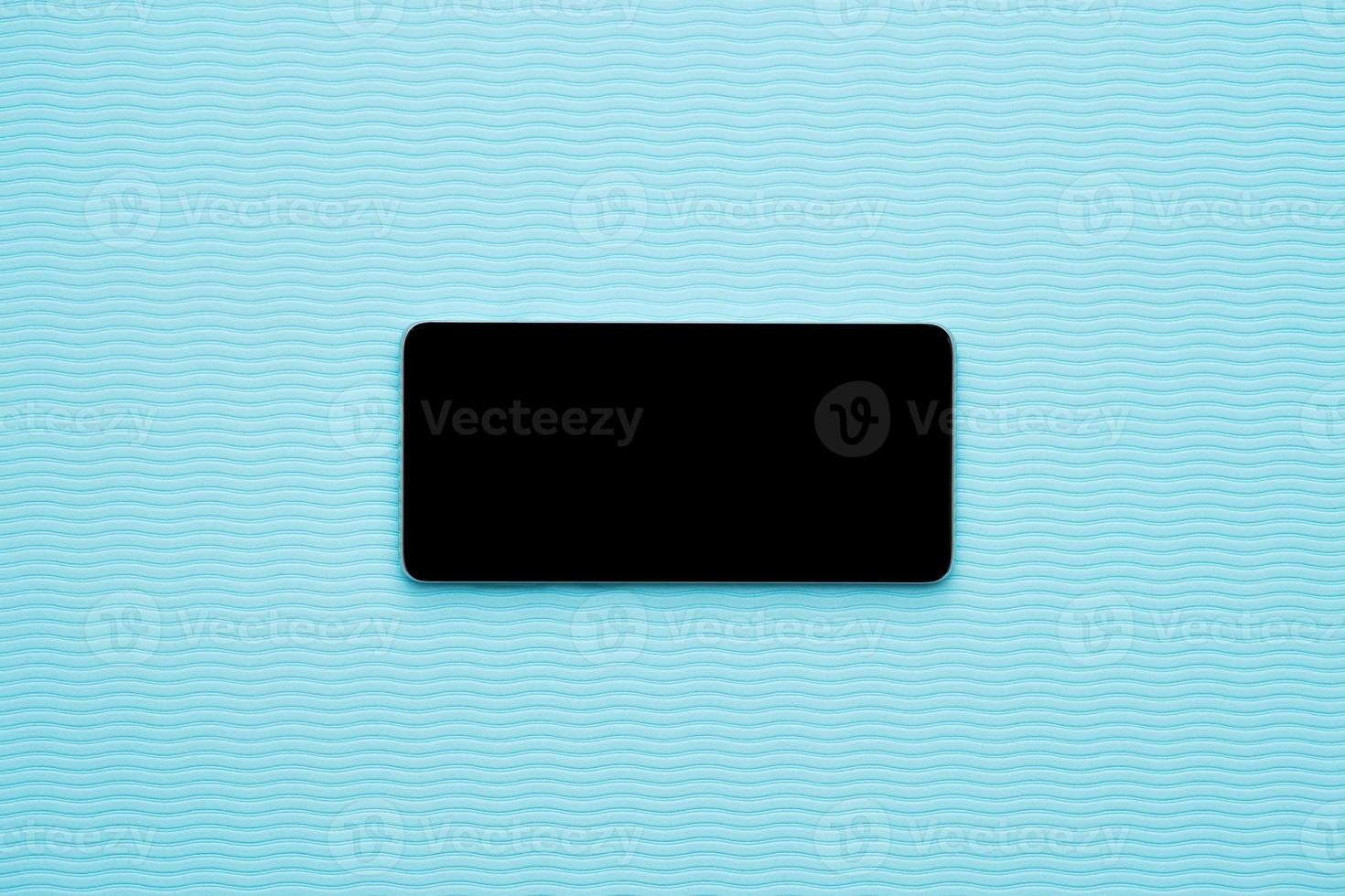Horizontal blank phone on blue wave background photo