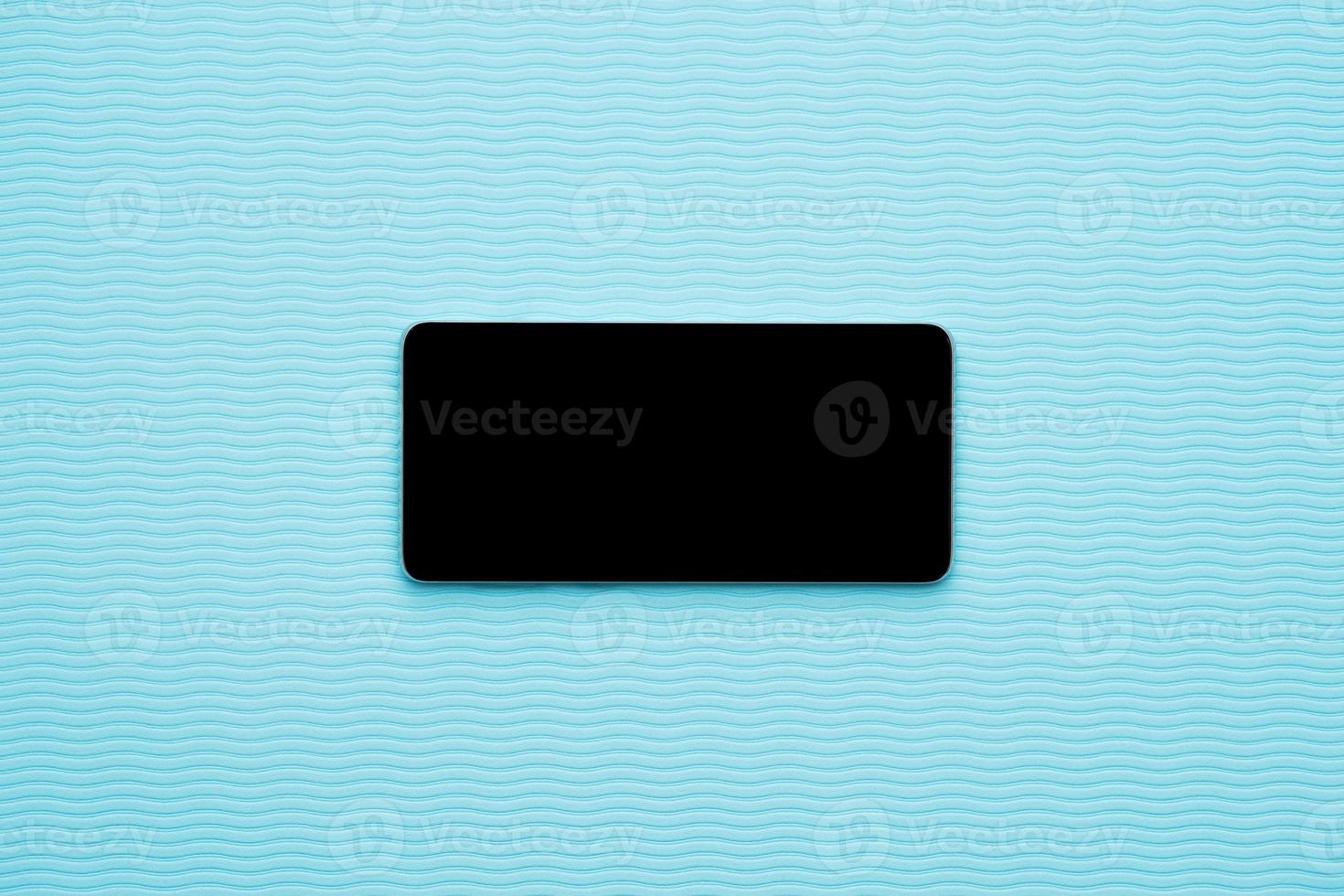 Horizontal blank phone on blue wave background photo