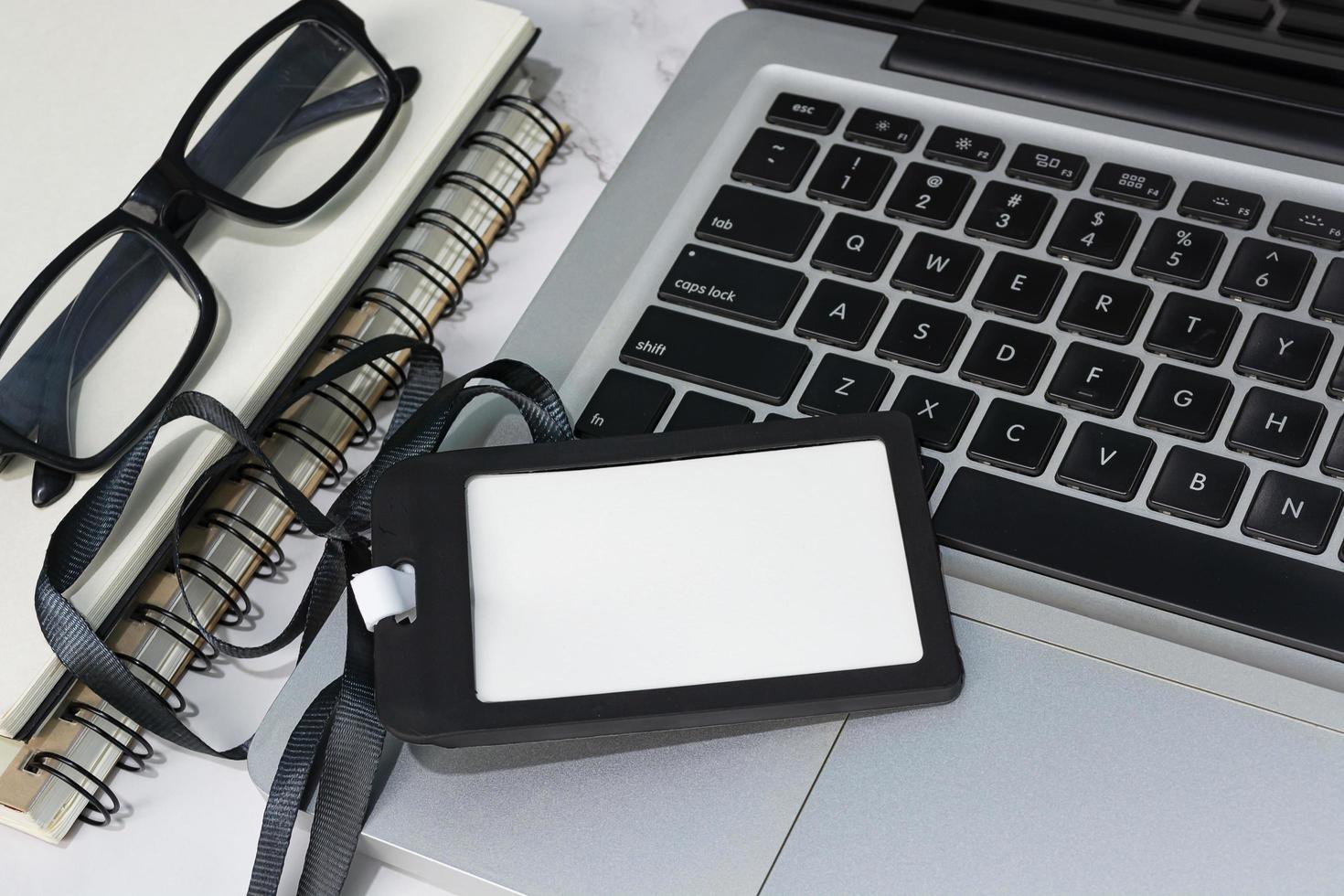 Black name tag placed on a laptop or notebook. Registration concept. photo