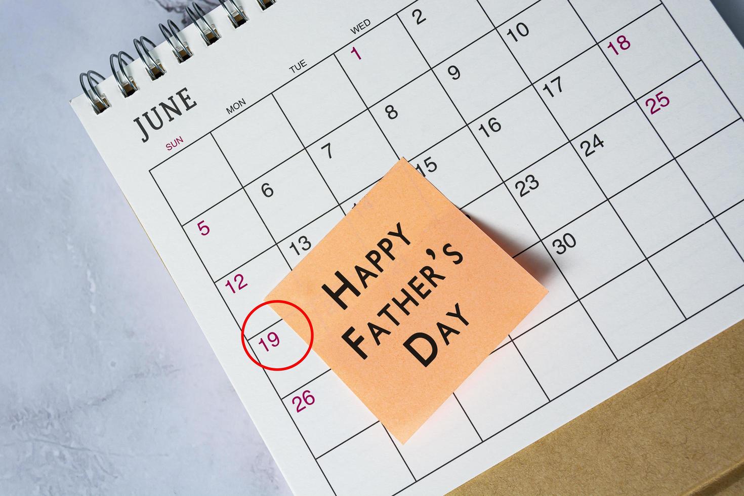 Happy Father's Day text on June 2022 calendar with date circle on 19th June. photo