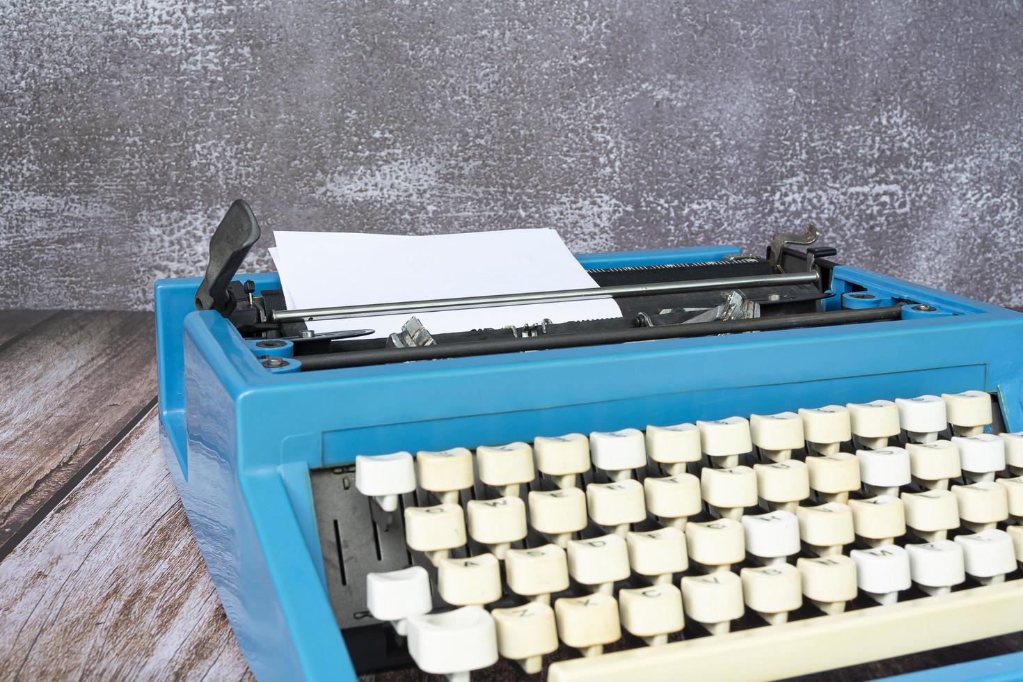 An old classic typewriter on wooden desk. Copy space. For text purpose. photo