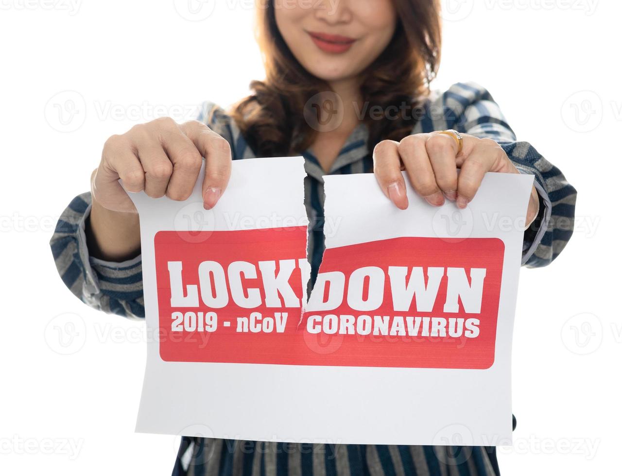 Woman holding and tearing paper with Covid-19 lock down announce words. The idea or concept for the ending, happiness and free after finishing and recovered from Coronarivus, on white background photo