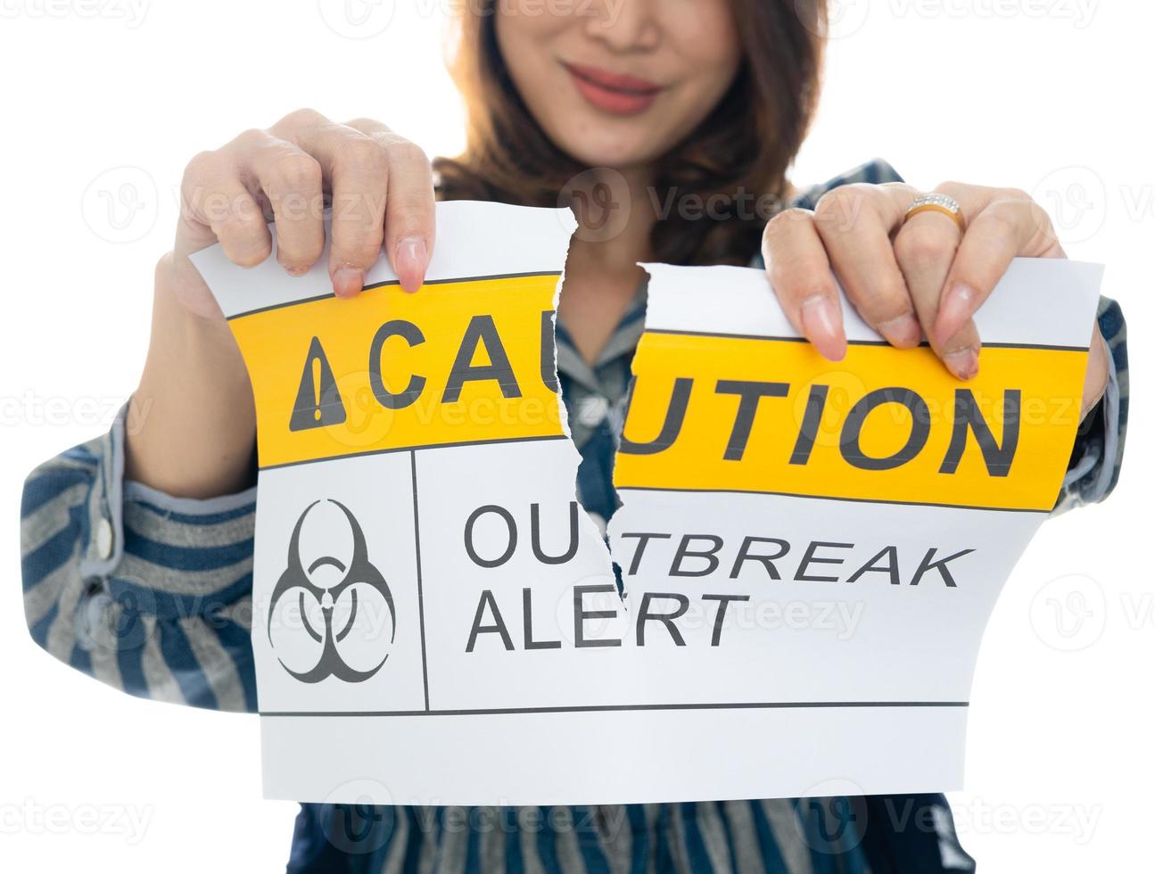 Woman holding and tearing paper with Covid-19 caution outbreak alert words. The idea or concept for the ending, happiness and free after finishing and recovered from Coronarivus, on white background photo