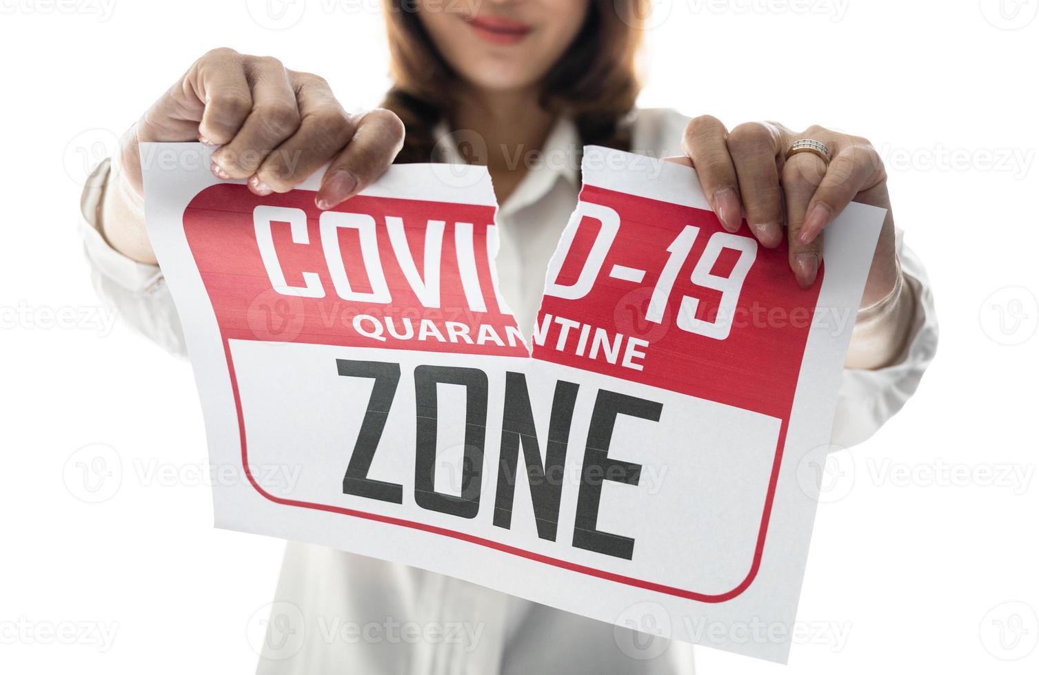 Woman holding and tearing paper with Covid-19 quarantine zone. The idea or concept for happiness, free and wellness after finishing and recovered from Coronarivus photo