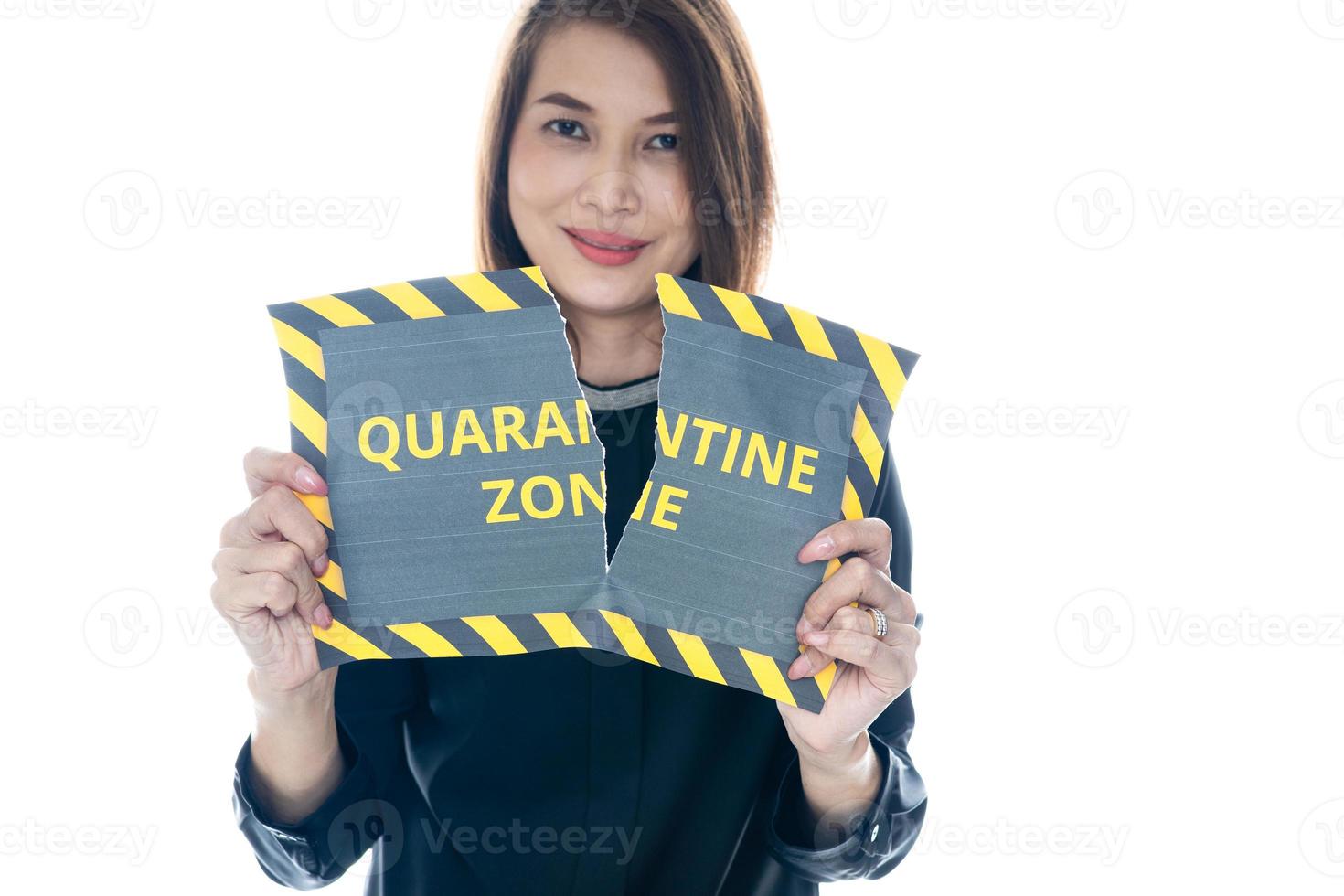 Woman shows and tearing paper with Covid-19 quarantine zone warning words. The idea or concept for the ending, happiness and free after finishing and recovered from Coronarivus photo
