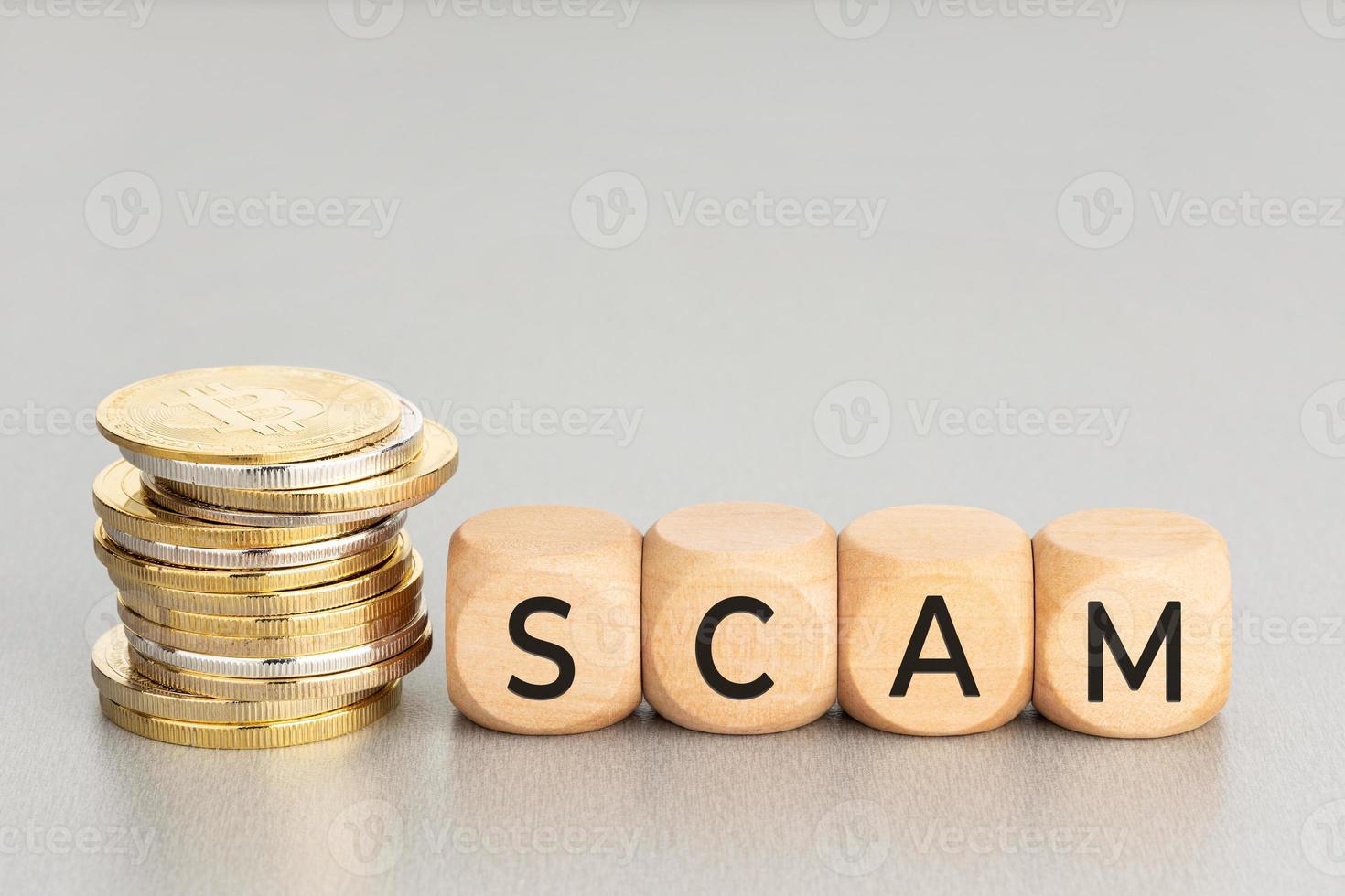 Cryptocurrency Scam concept. Stacked crypto coins and wooden blocks with text. Copy space photo