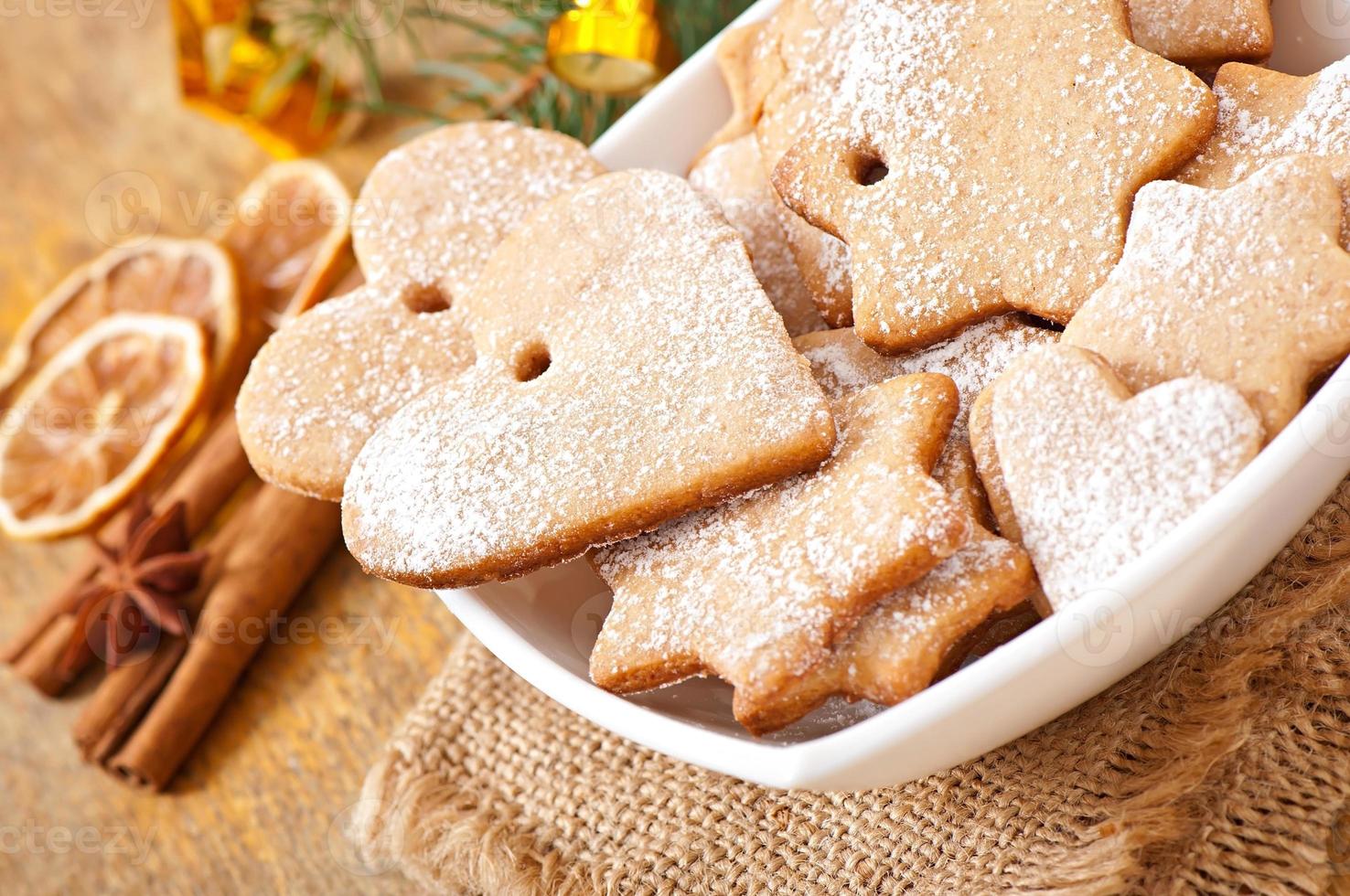 Homemade Christmas cookies sprinkled with powdered sugar photo
