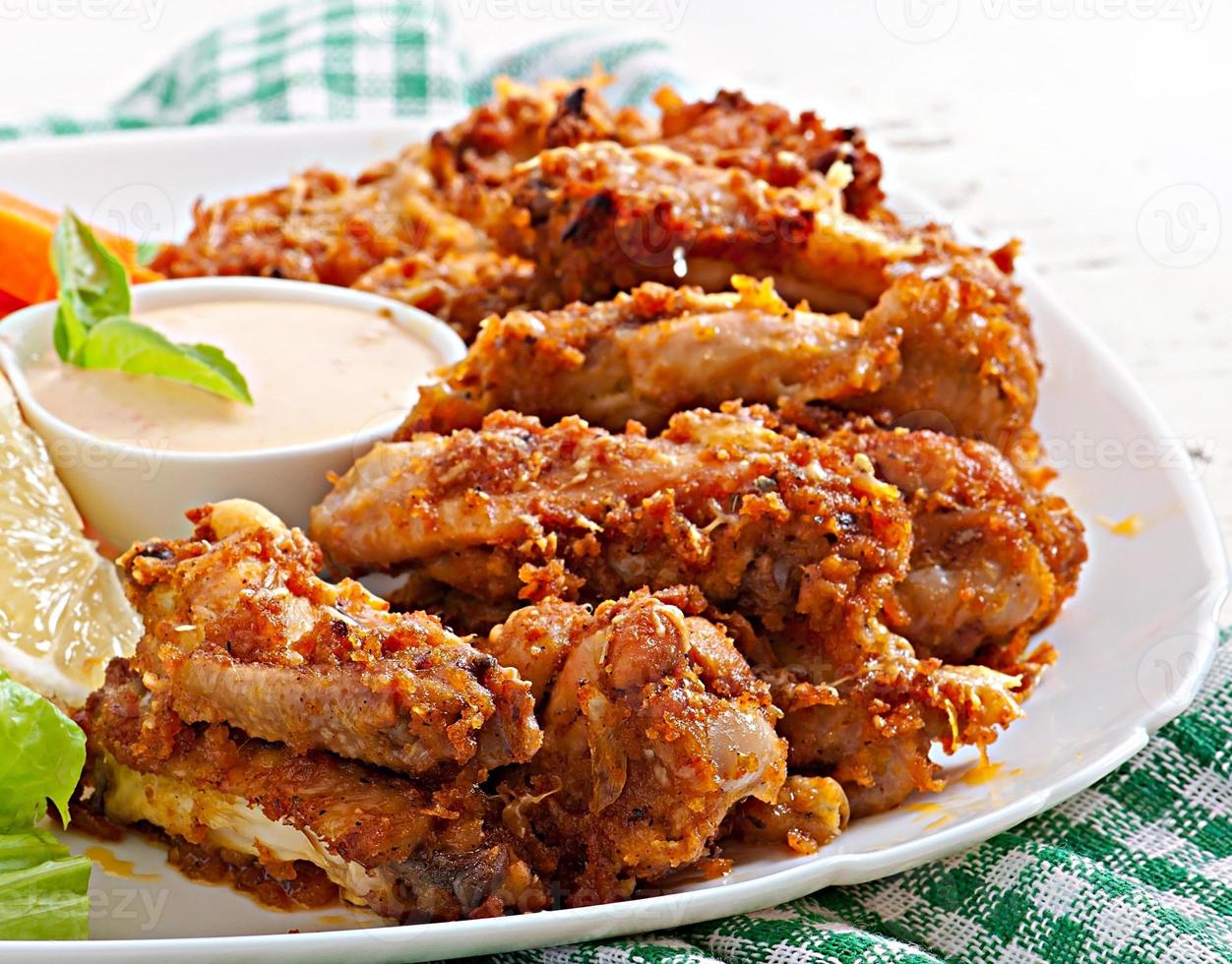 Chicken wings with parmesan cheese in the oven photo