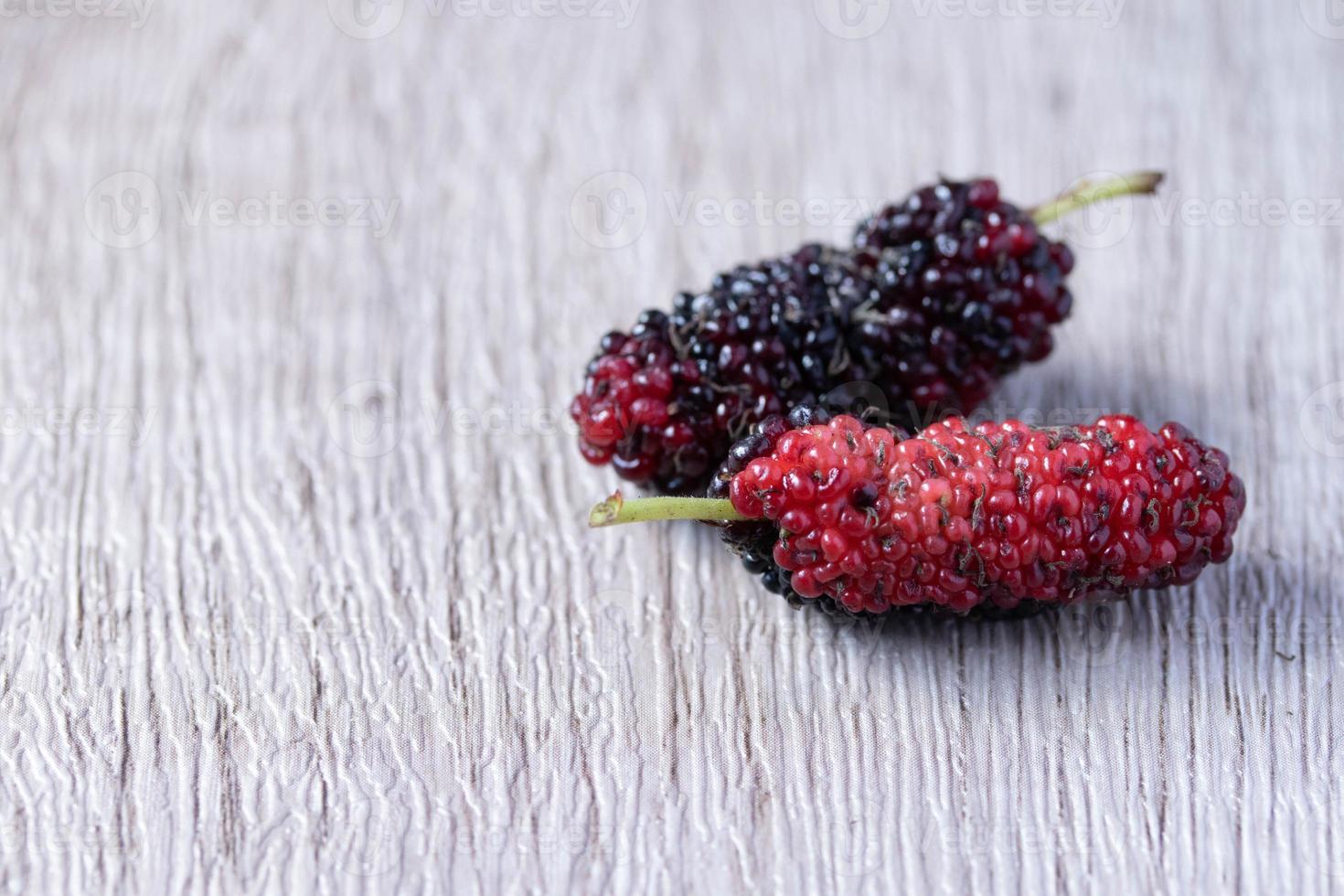 fresh mulberries on wooden background photo