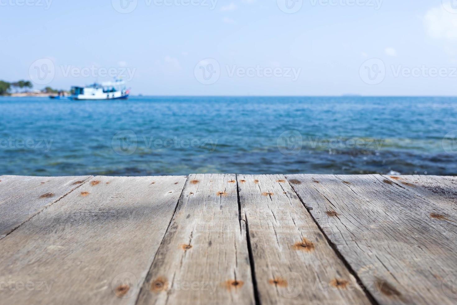Close up with wooden walkway and view of sea and blue sky photo