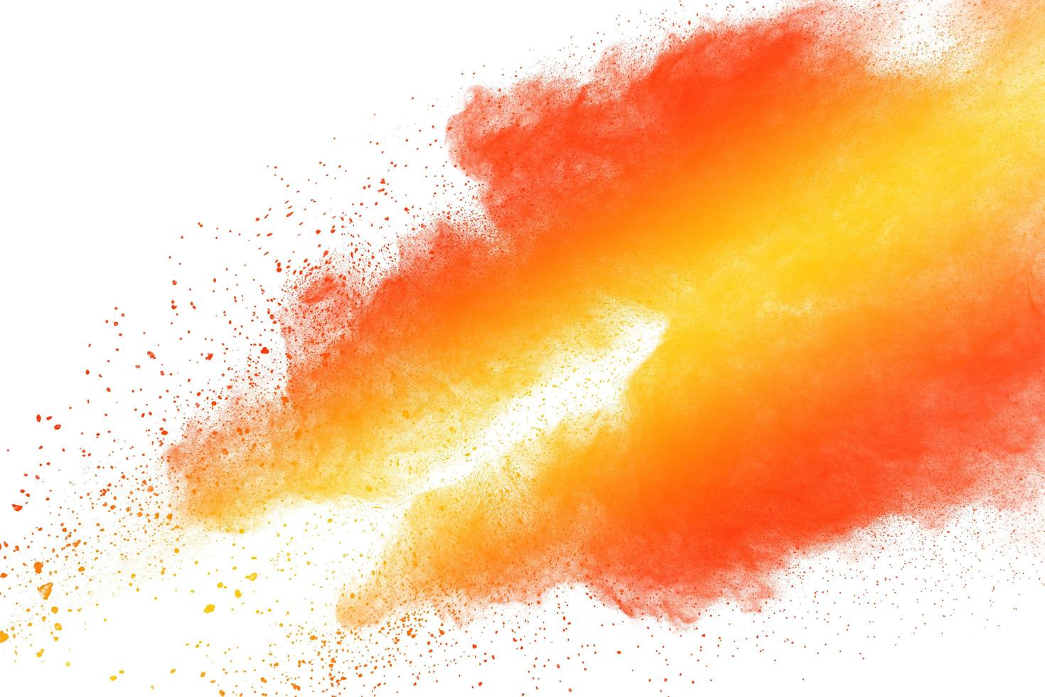 Abstract yellow orange powder explosion on white background. Freeze motion of orange  dust particles splash. photo