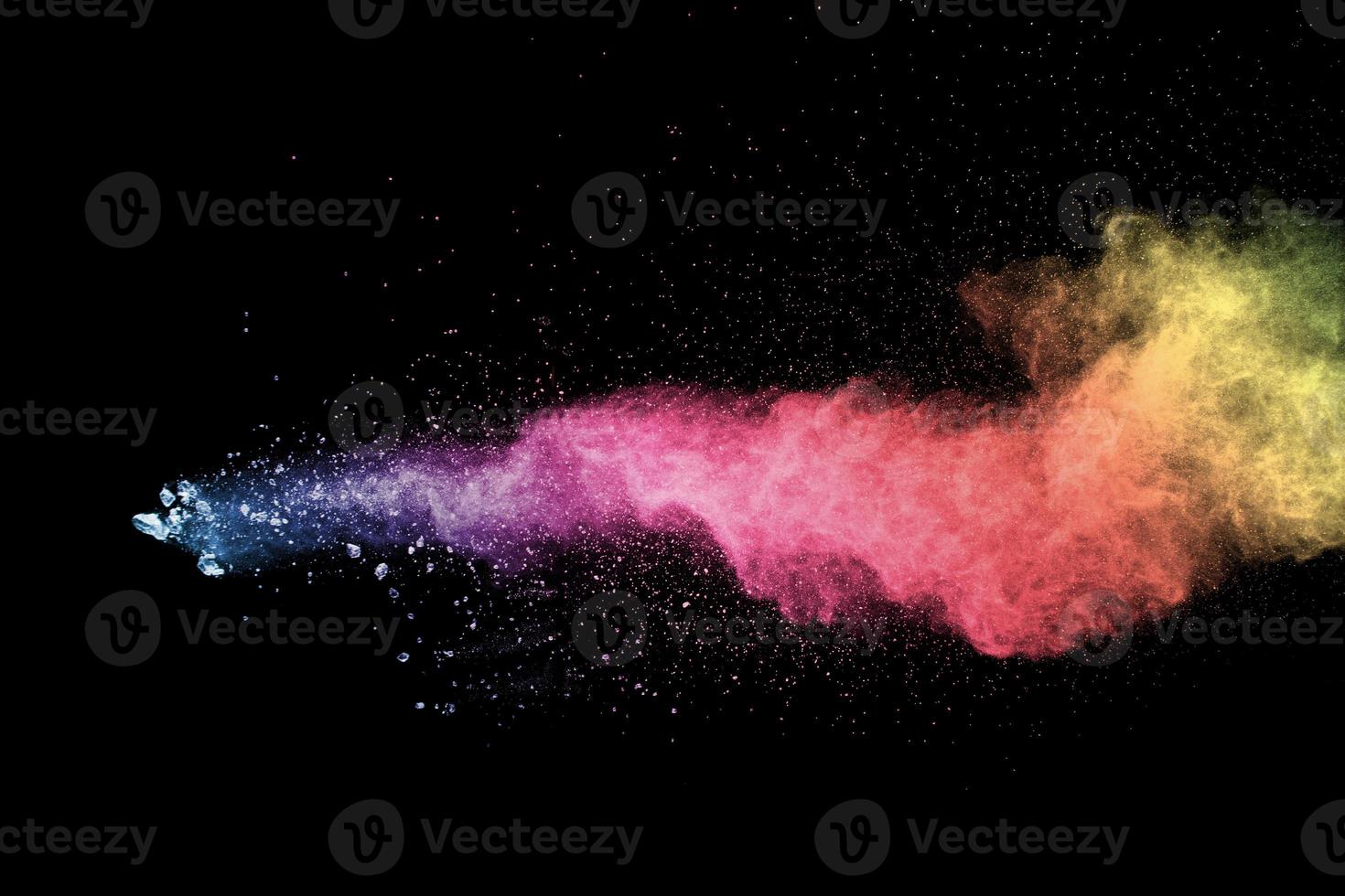 Explosion of color powder on black background. Splash of color powder dust on dark background. photo