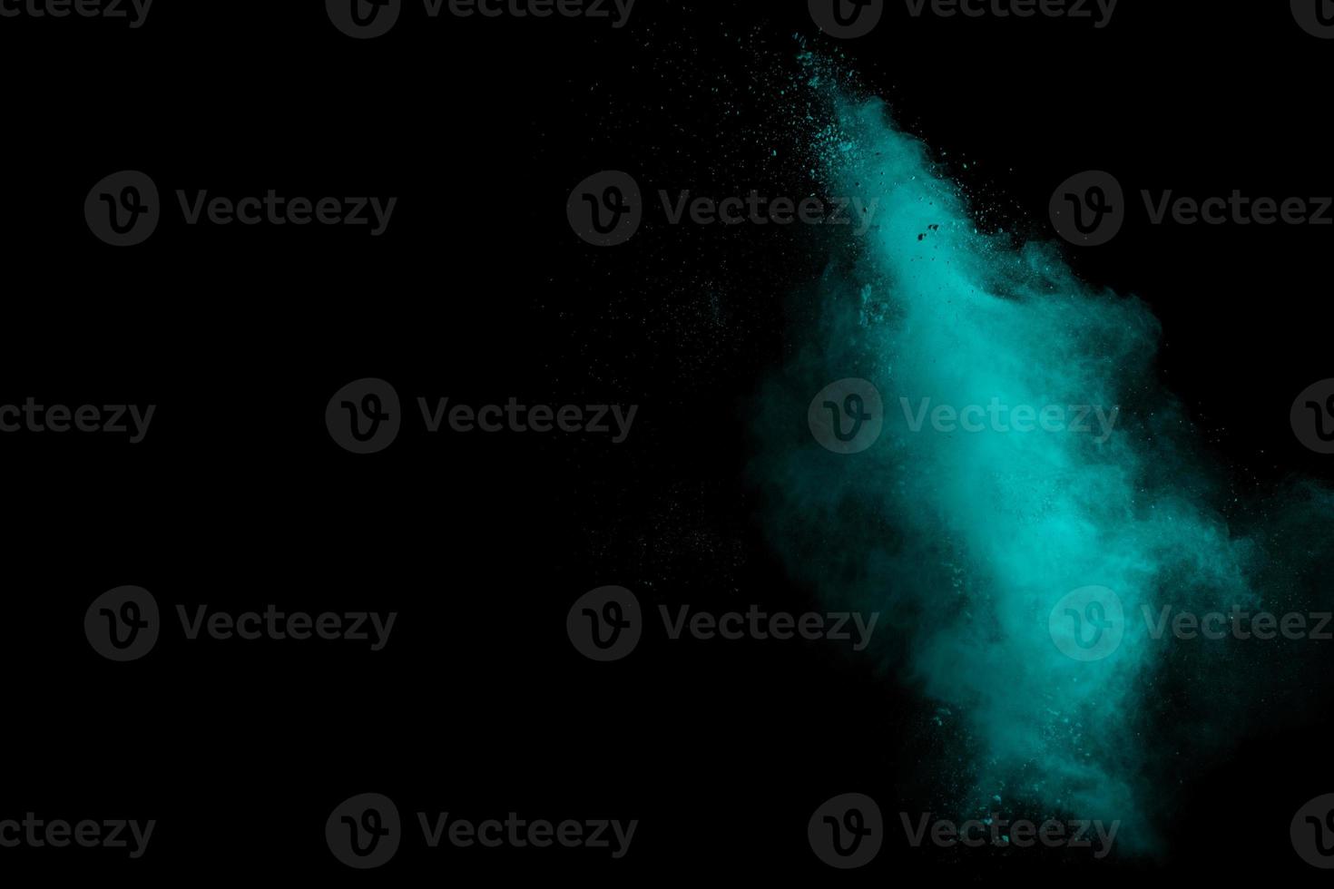 Green color powder explosion on black background. photo