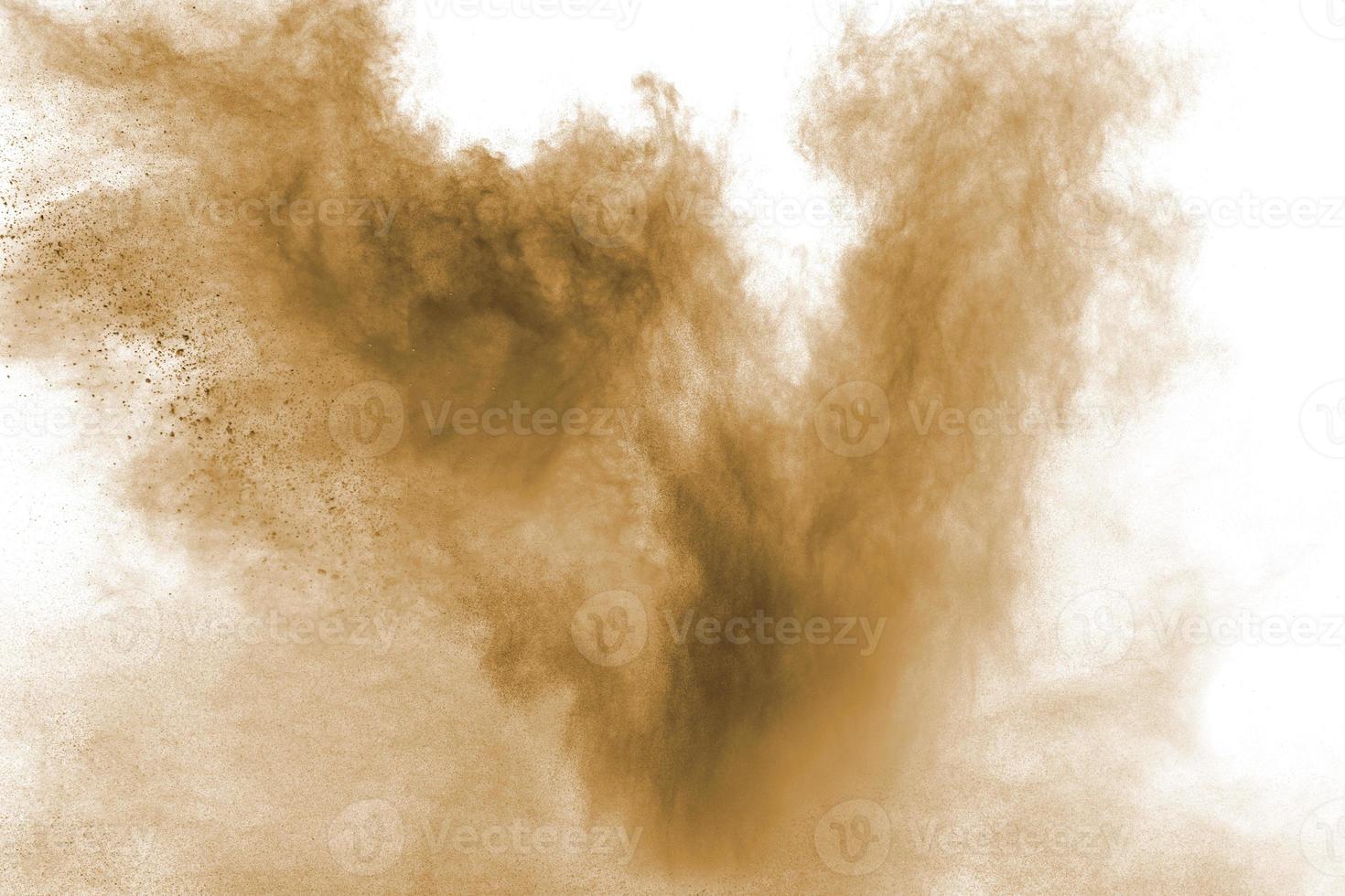 Abstract deep brown dust explosion on white background.  Freeze motion of coffee liked color dust splash. photo