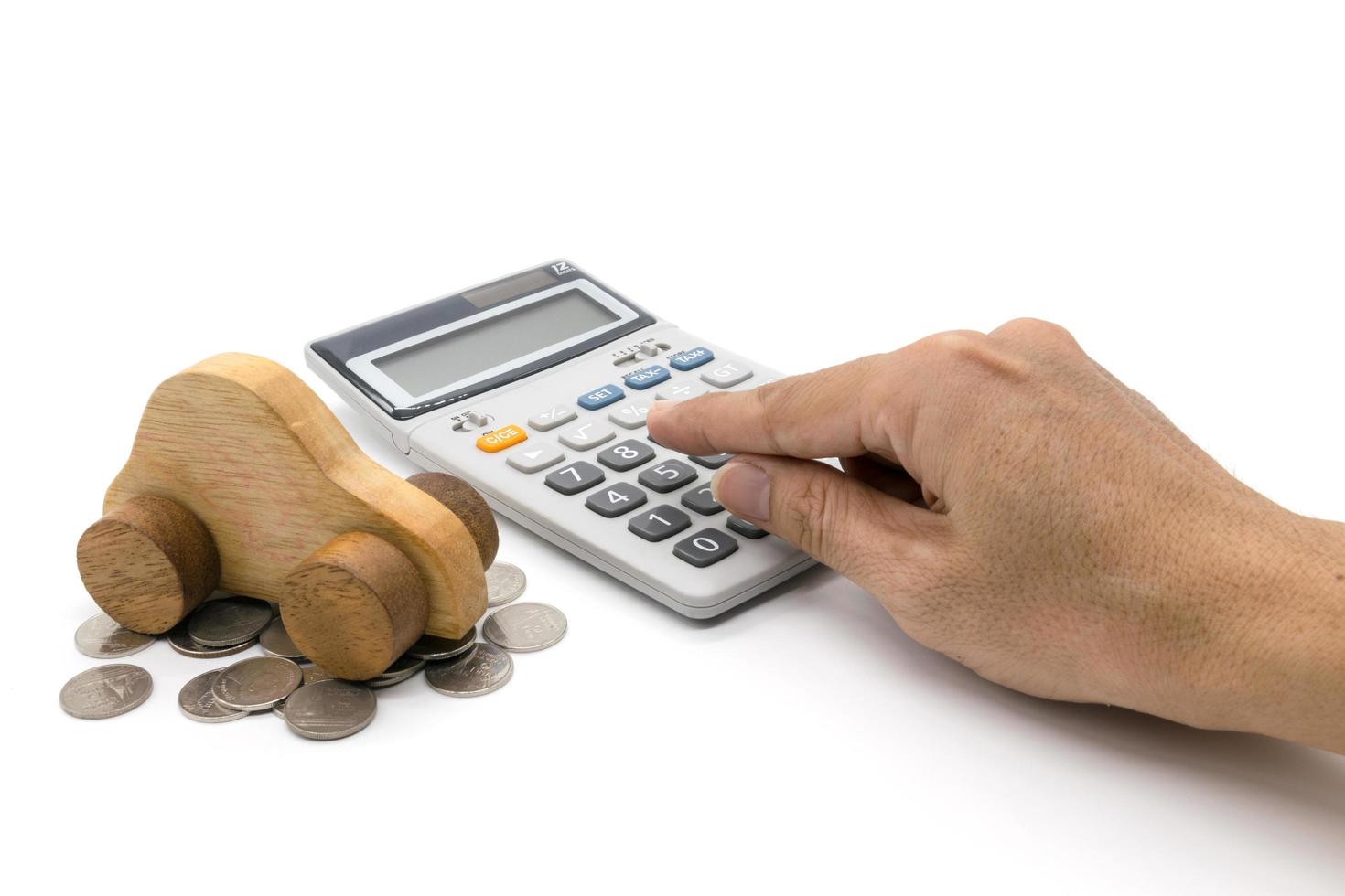 Calculator and car wood and hand on white background photo