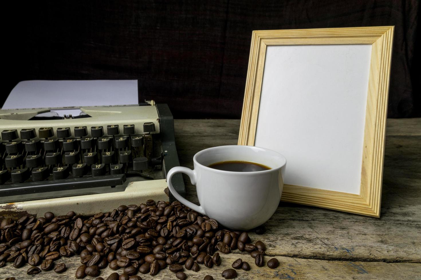 typewriter and coffee on wood background photo