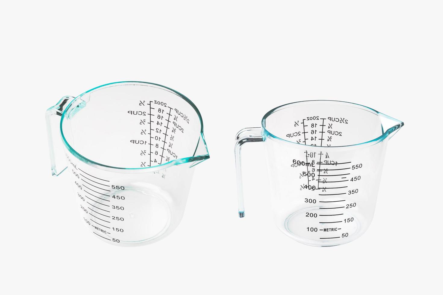 Empty Clear Color Plastic Graduated Measuring Cup or measuring jug  on white background photo