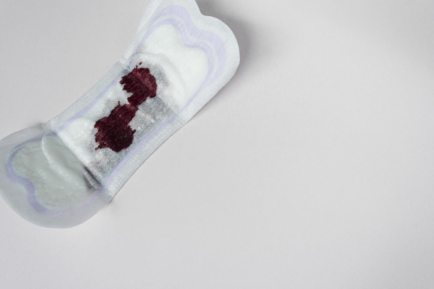 Menstrual blood on a sanitary pad. Flat lay. Copy space. photo