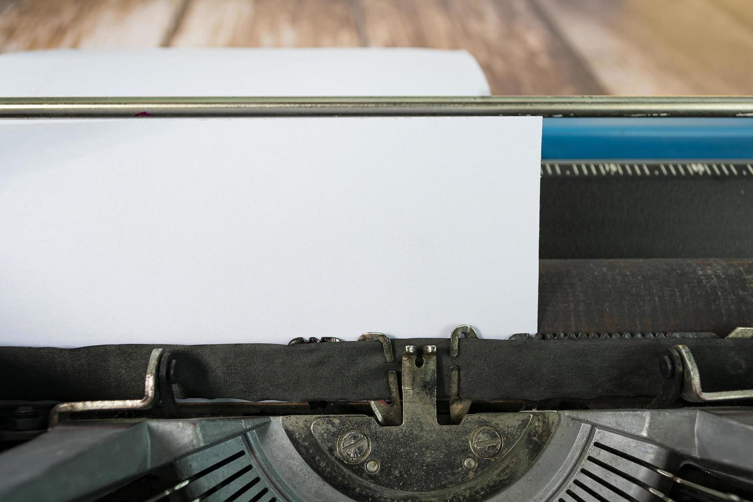 An old classic typewriter on wooden desk. Copy space. For text purpose. photo