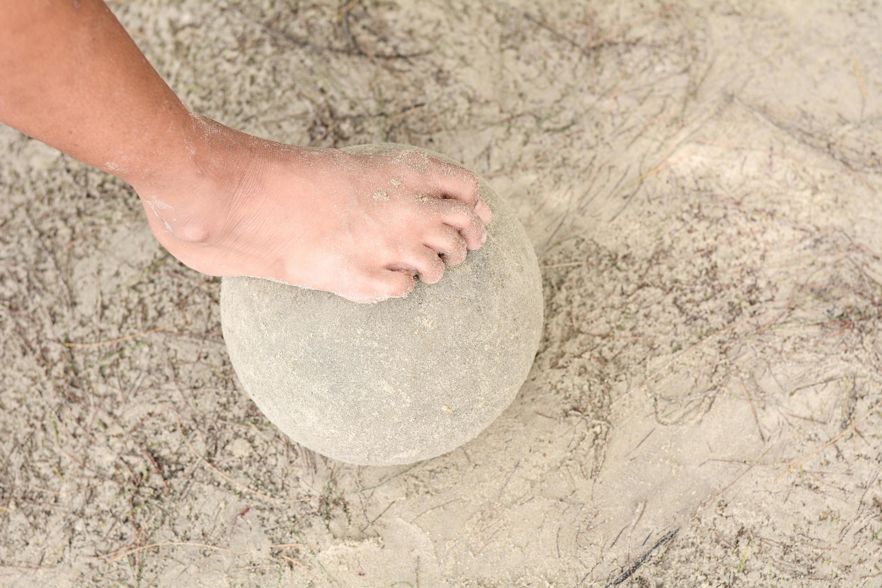 Children step on the ball with their feet. 7161978 Stock Photo at Vecteezy