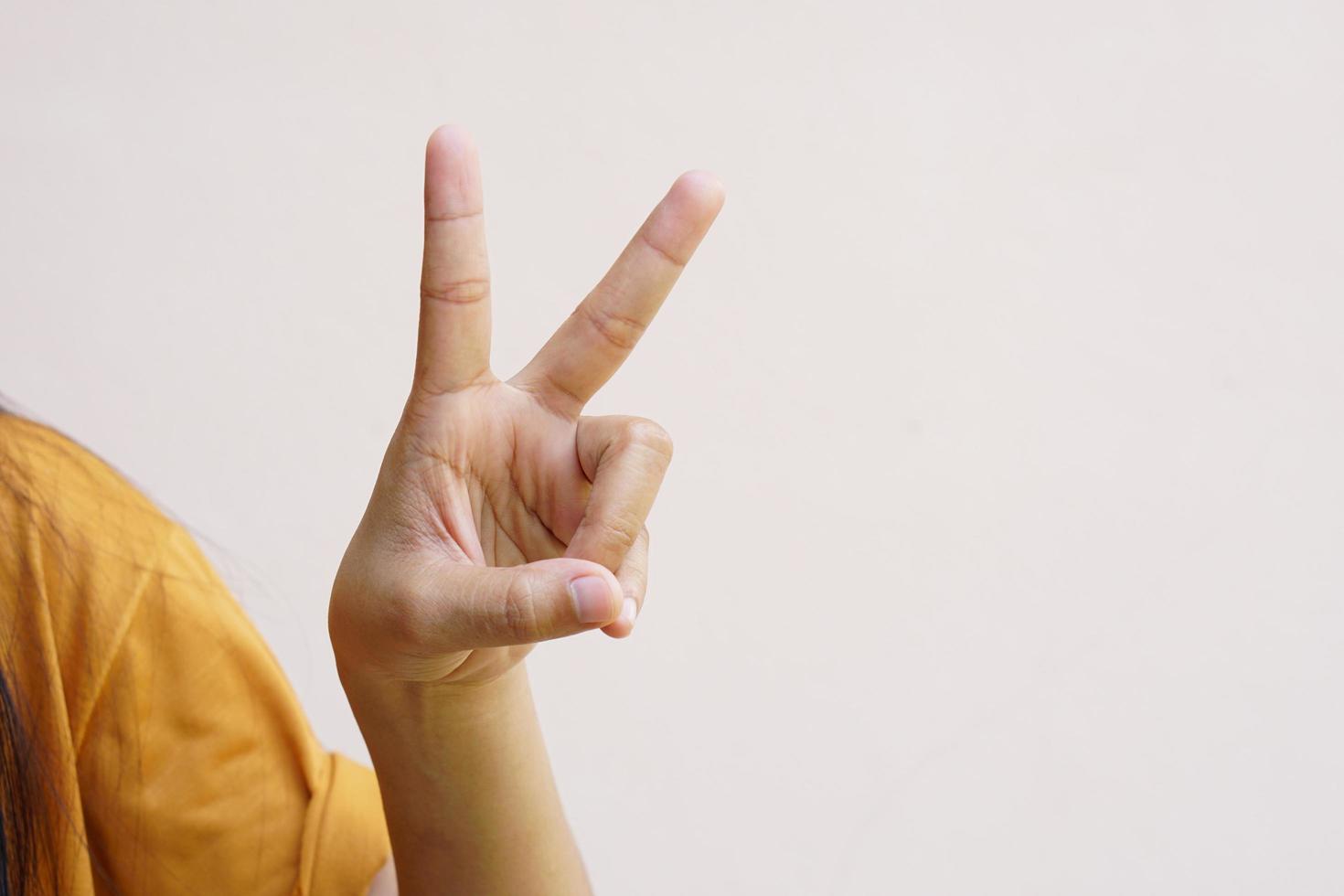 Two thumbs up Asian woman's hand as a symbol of encouragement photo