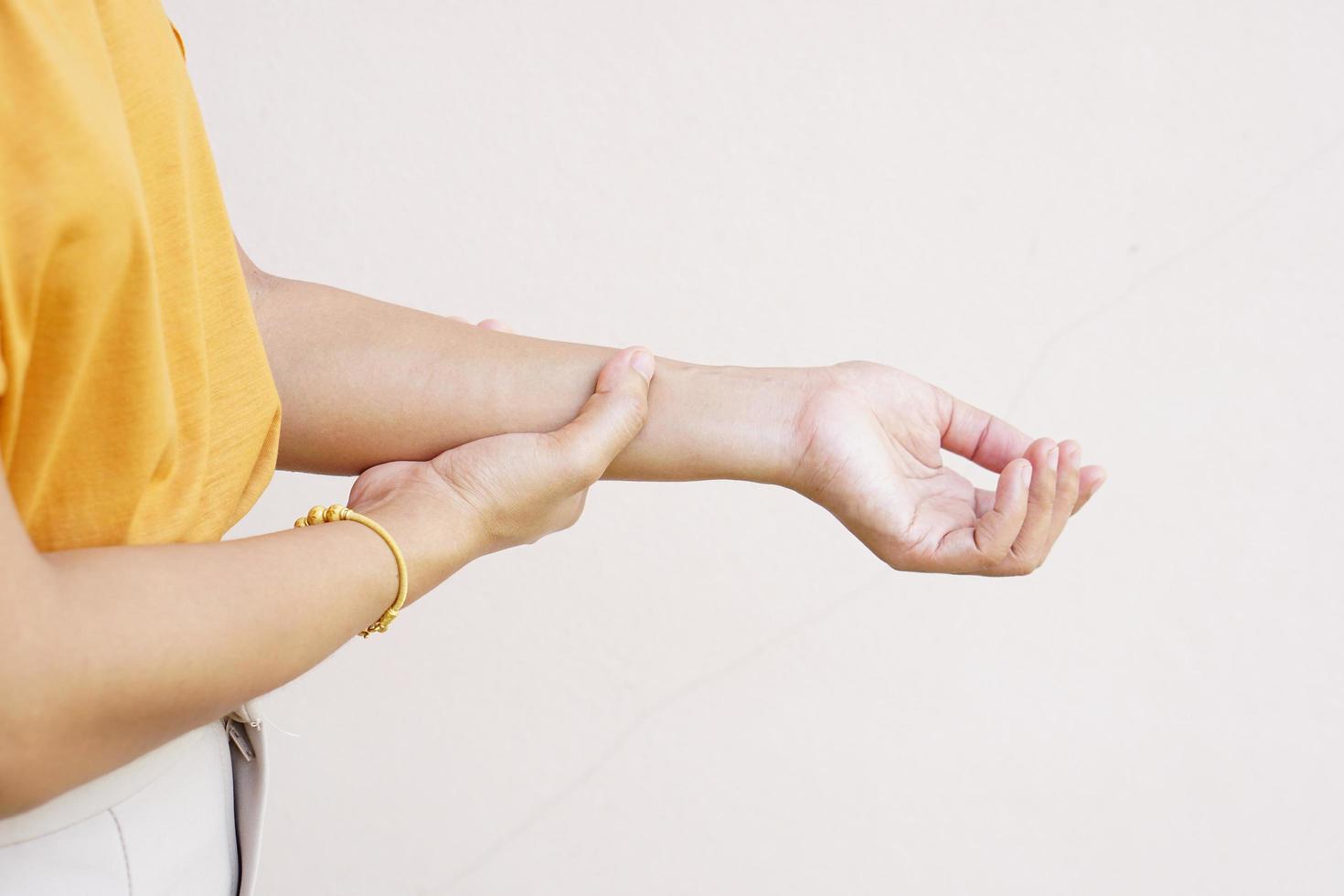 Woman holding her wrist pain from using computer, office syndrome photo