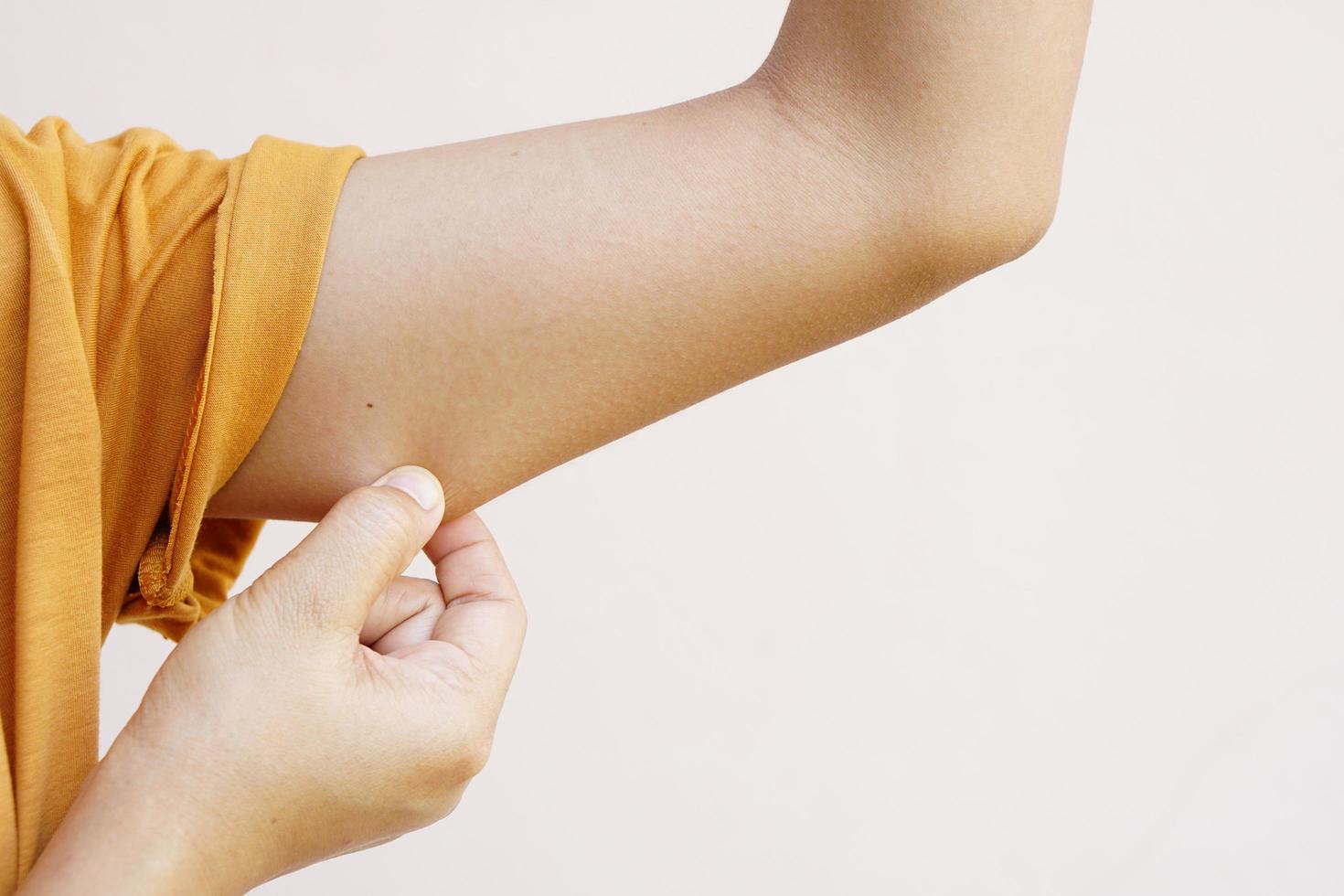 Asian women use their hands on the skin under their arms to see if they have a lot of fat or flabby. photo