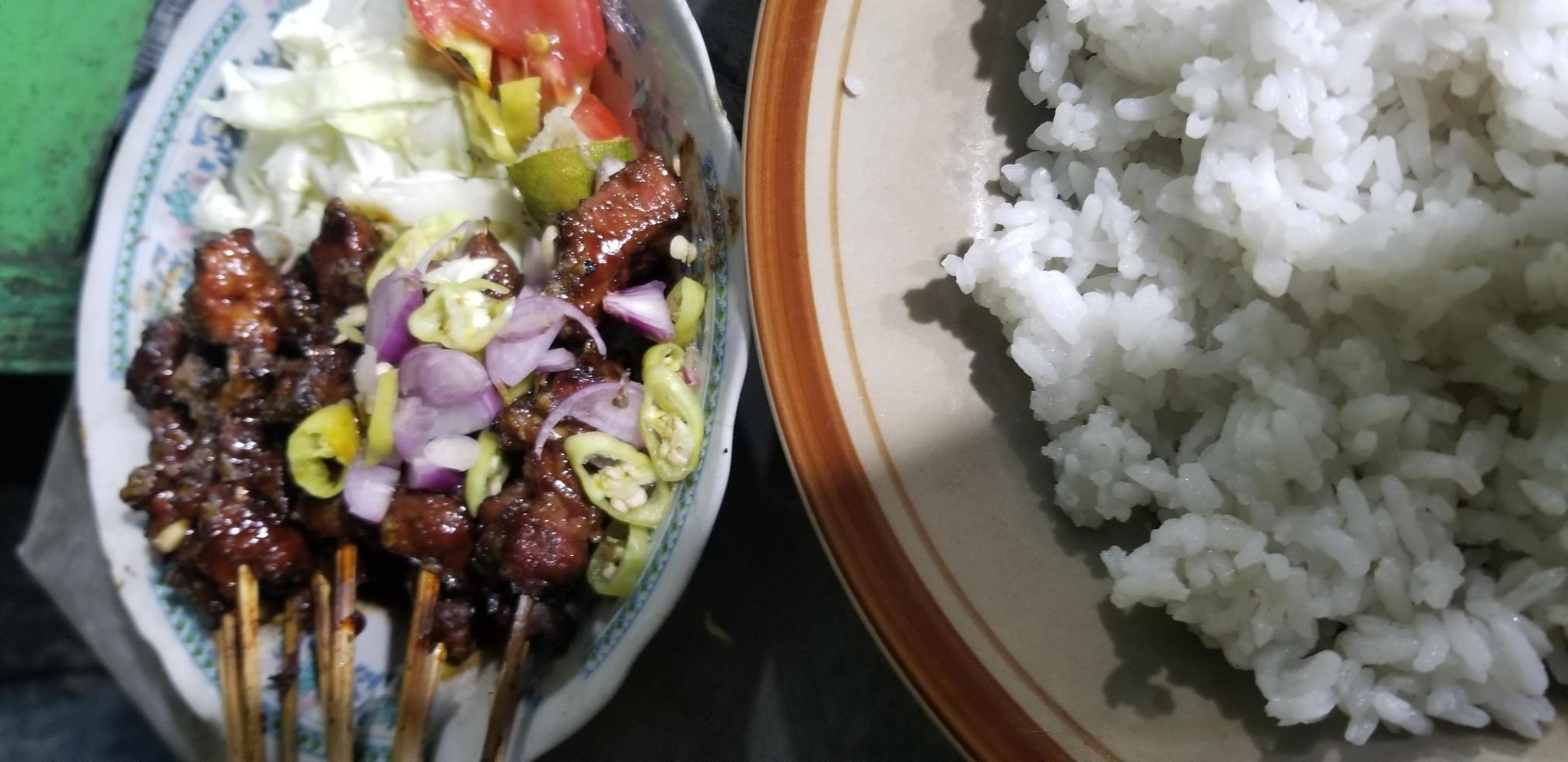 mutton satay with spices and a plate of rice photo