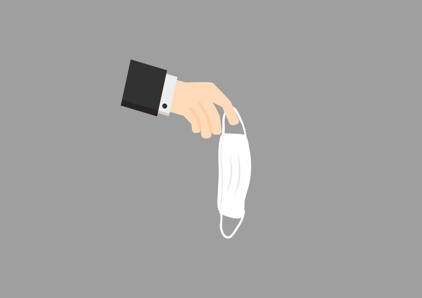 hand holding a medical mask for thrown away on dark background vector
