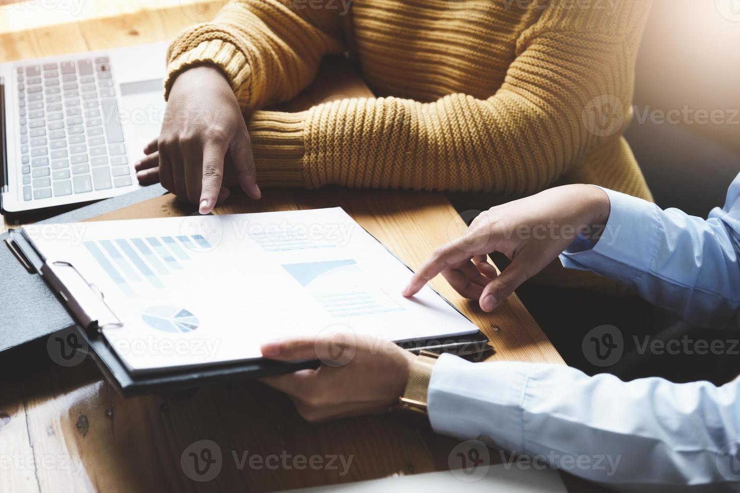 A female business consultant describes a marketing plan to set business strategies for women business owners. photo