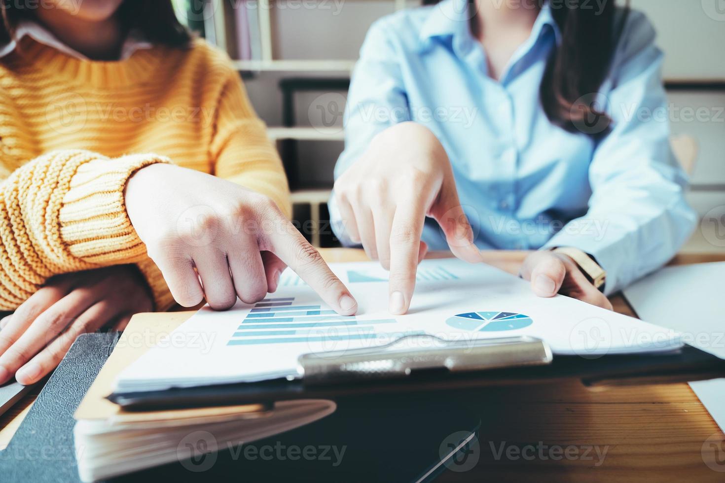 A female business consultant describes a marketing plan to set business strategies for women business owners. photo