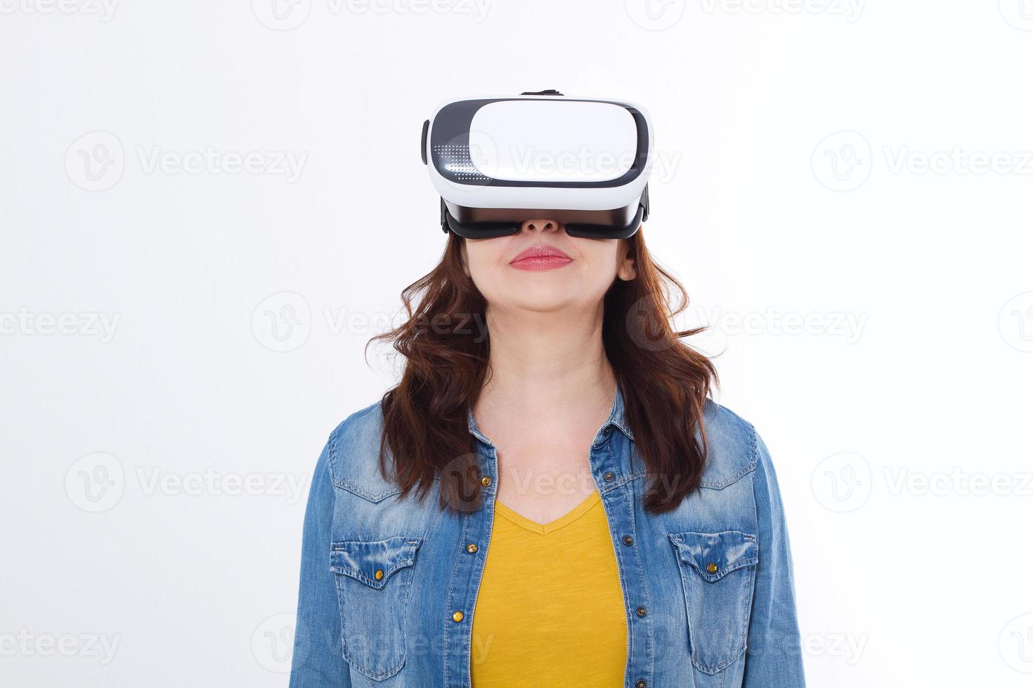 Woman wearing VR headset and looking up in virtual reality isolate on white background. Computer technology. Copy space and mock up. photo