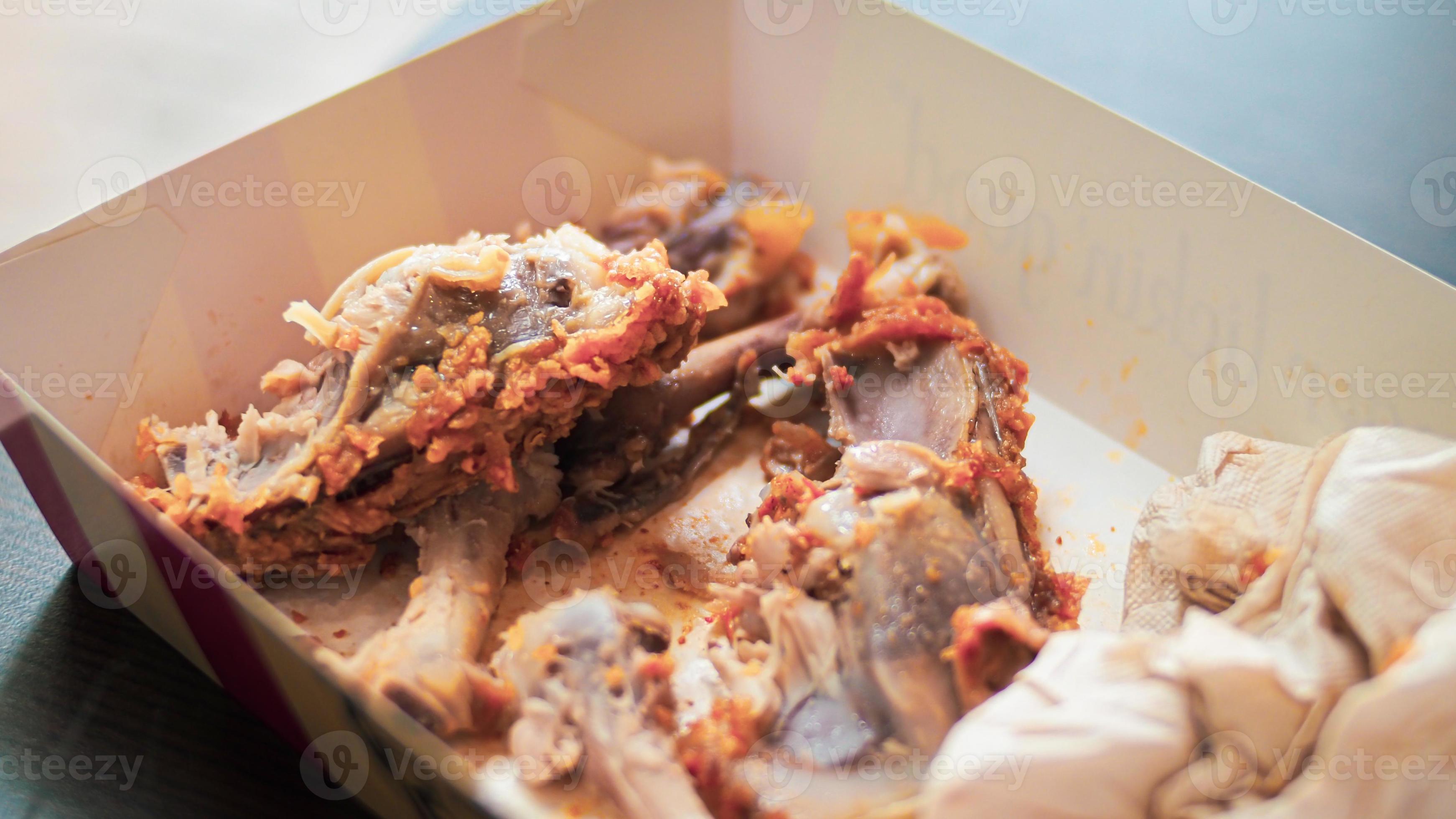 Food waste concept. Bones of fried chicken in a restaurant 7180707 Stock Photo at Vecteezy