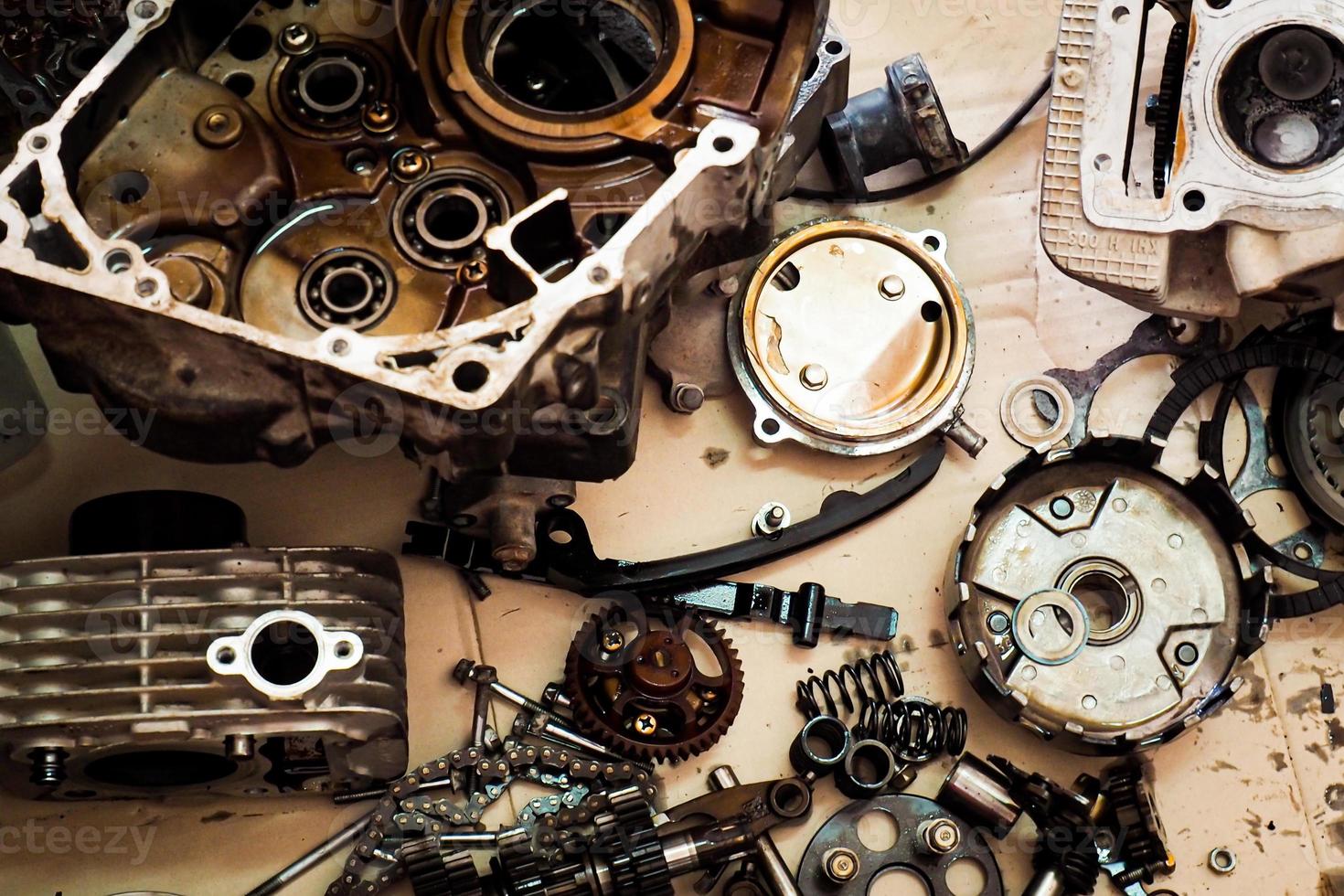 Parts of a motorcycle engine removed for maintenance. engine maintenance concept photo