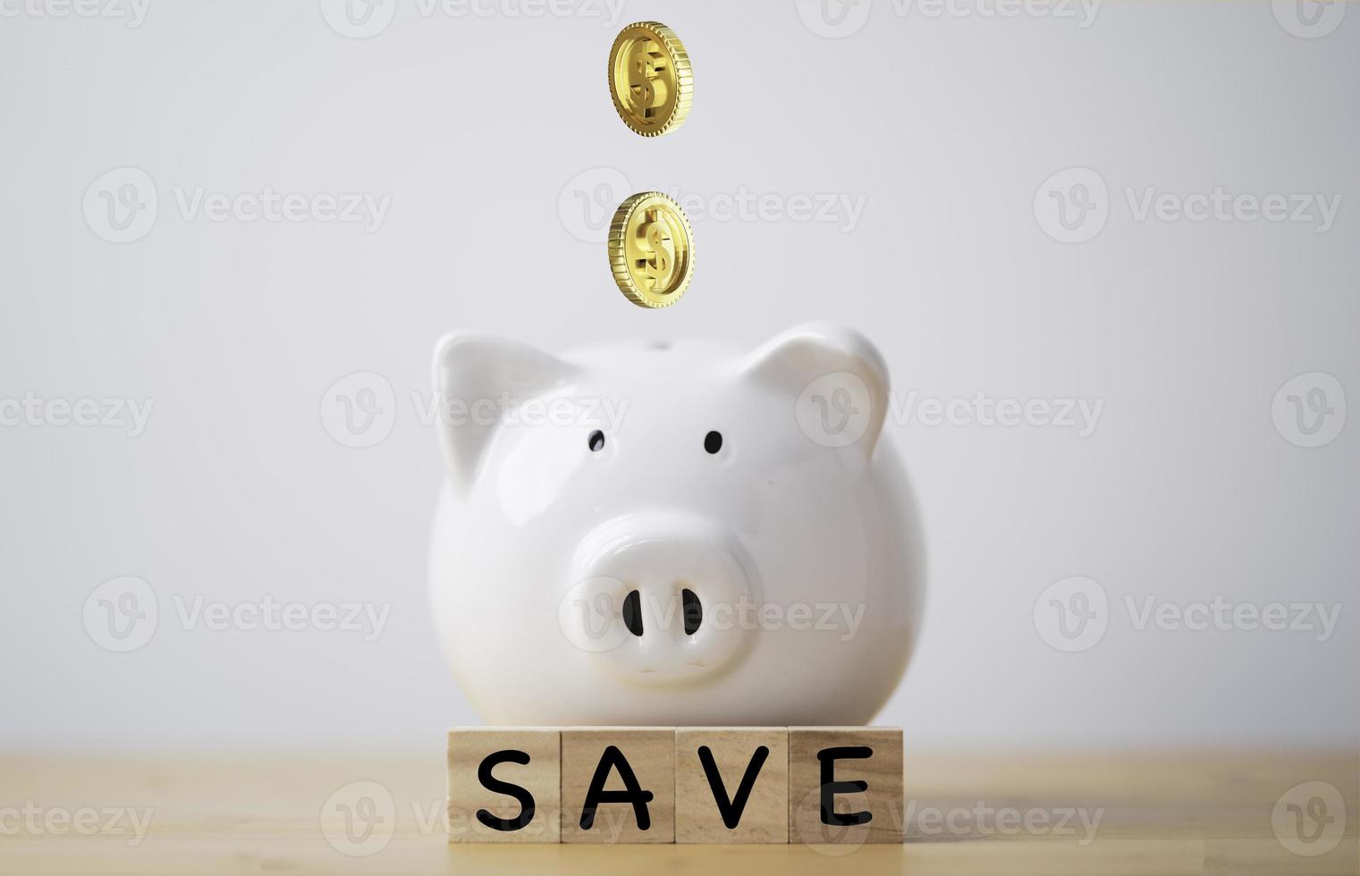 Golden coins drop to piggy bank saving with save wording for money deposit and financial investment concept. photo