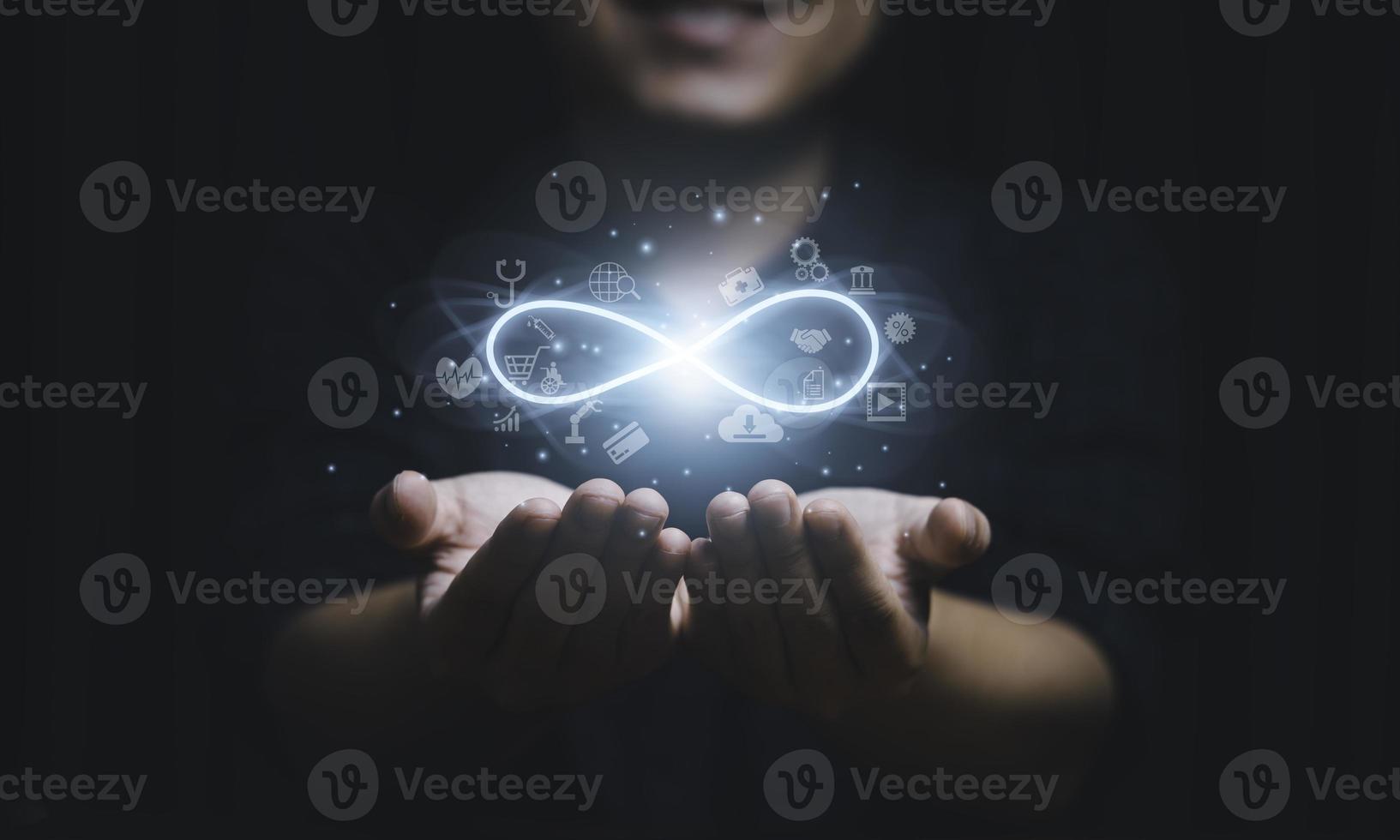 Hands holding virtual infinity with technology icon for symbol of connection to community metaverse world network system concept. photo