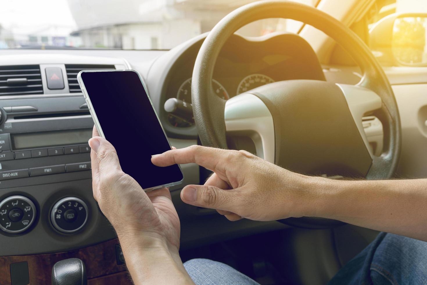 man driving car and using mobile phone photo