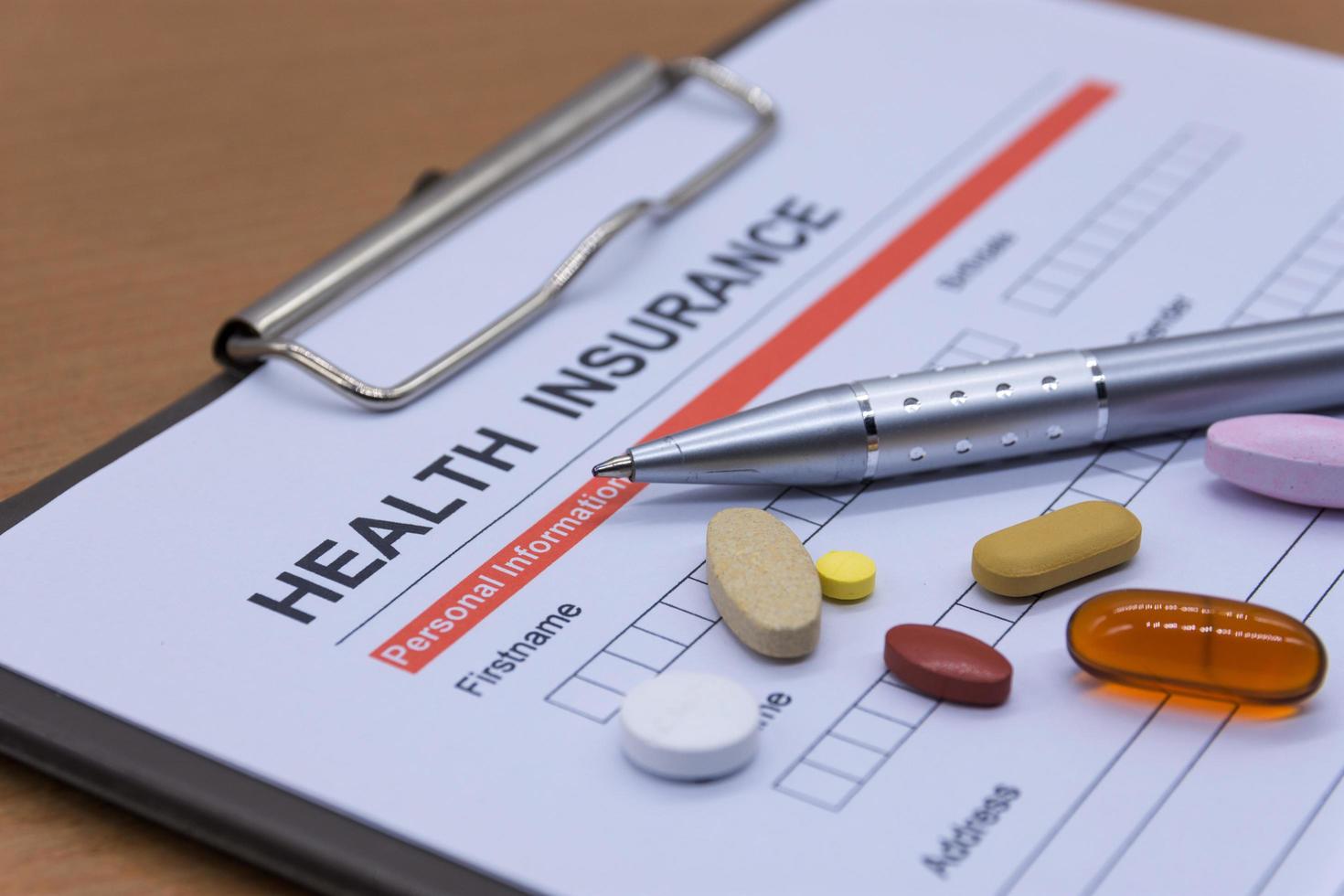 Health insurance paperwork, medicine, stethoscope. Health insurance claim concept. photo