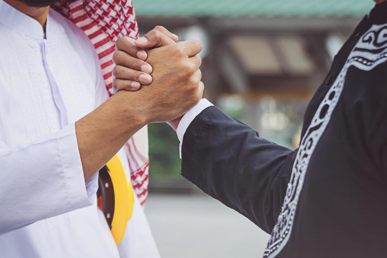 Arab businessmen worker handshaking on construction site photo