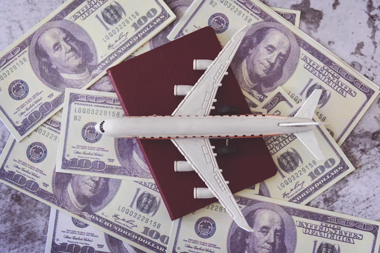 Airplane model and passport on dollars photo
