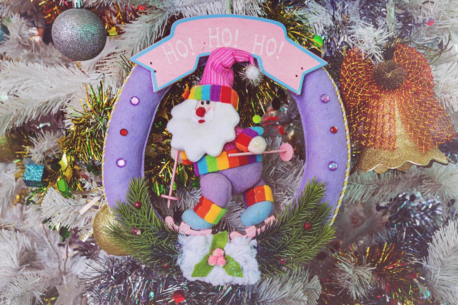 Santa Claus dolls and Christmas decorations box on wooden photo