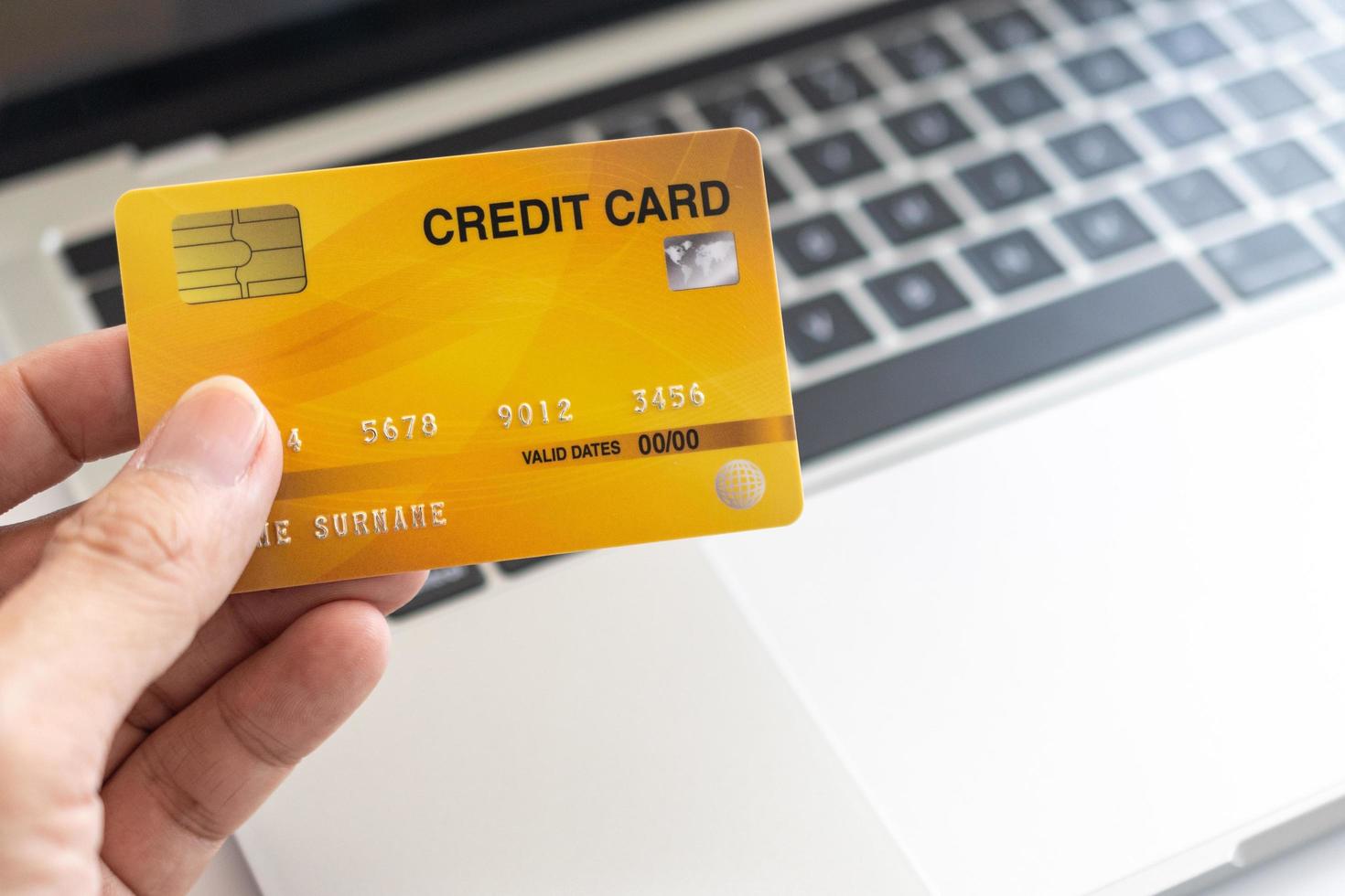 Man holding credit card on laptop. On-line shopping on the internet using a laptop photo