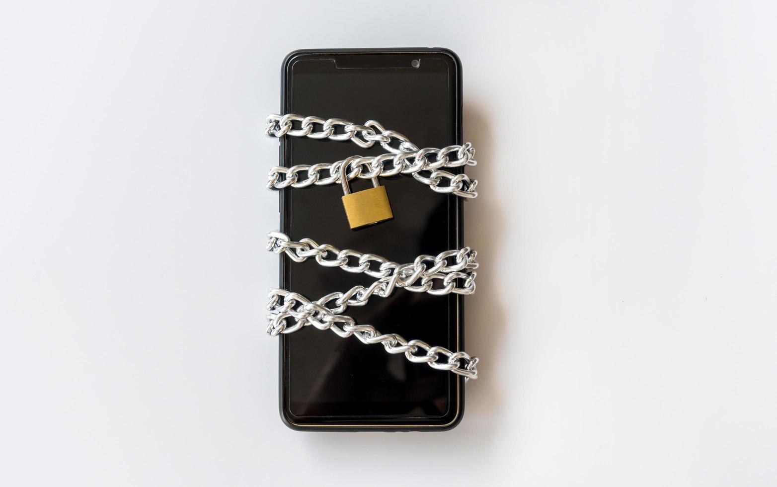 Smartphone with chain and padlock, Safety concept. photo