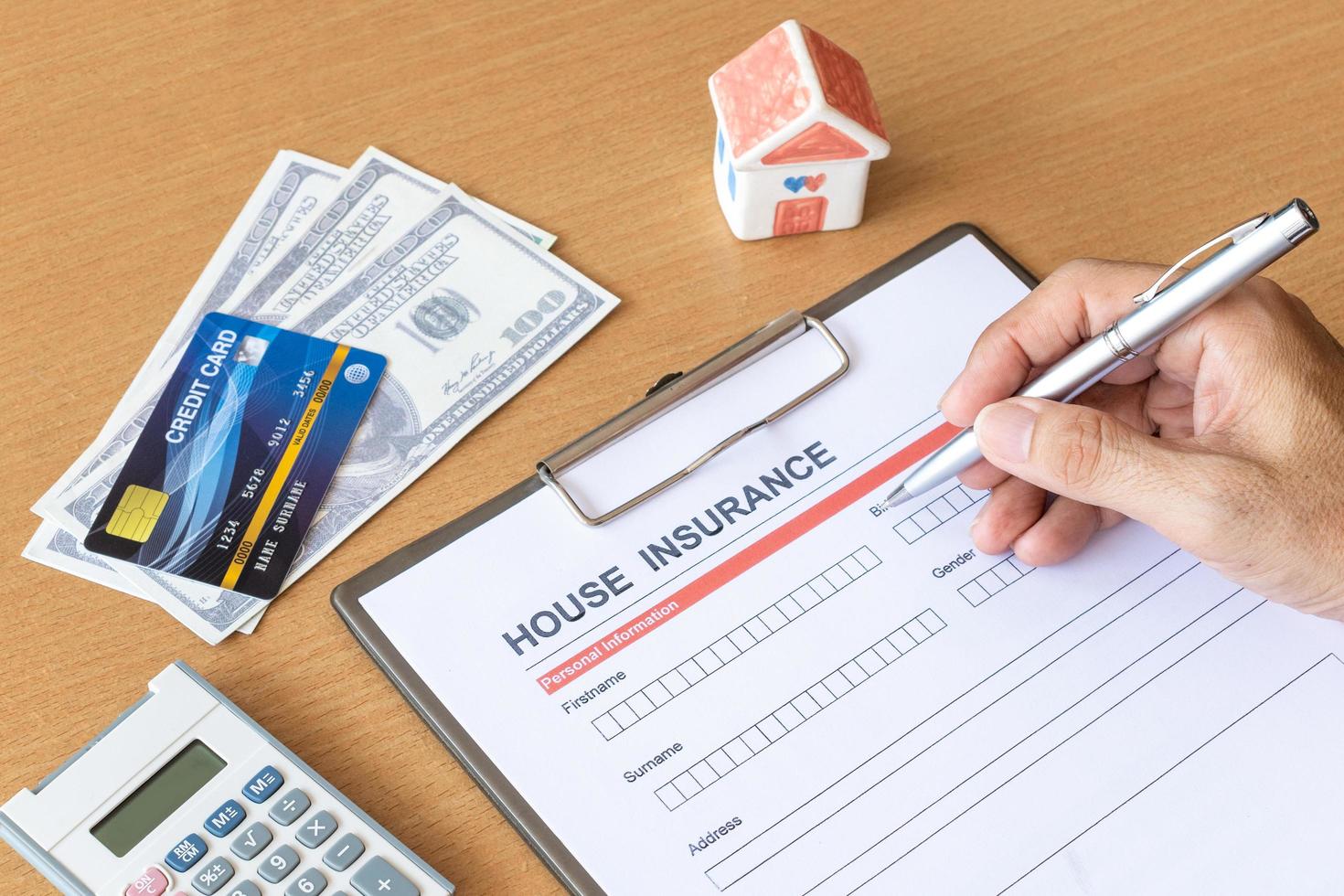 House insurance form with model and policy document photo