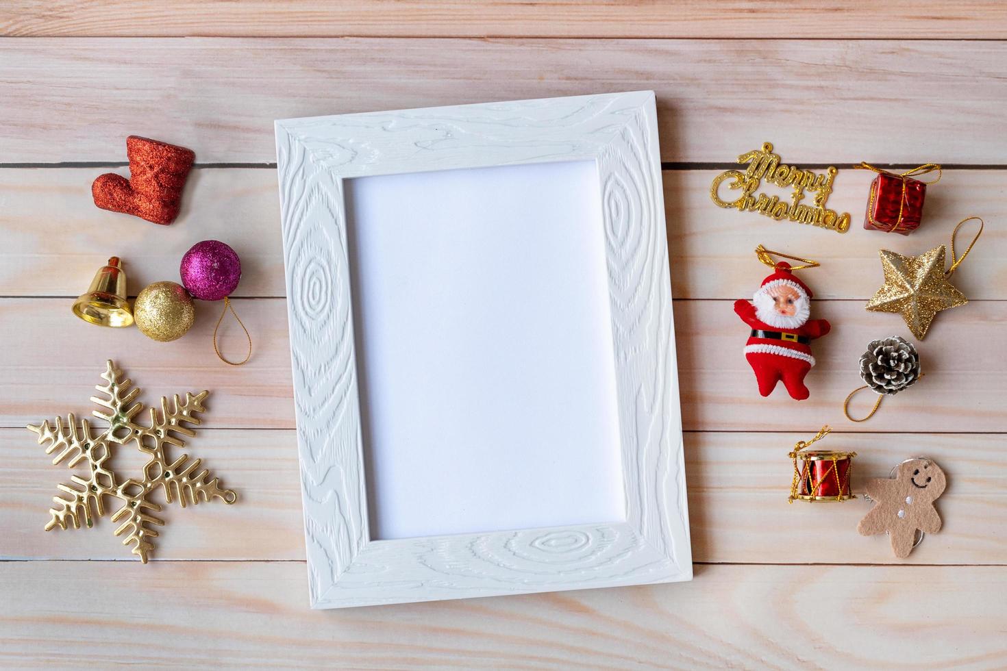 Picture frame and Christmas decoration - Santa Clause and gift on wooden table. Christmas and Happy new year concept photo