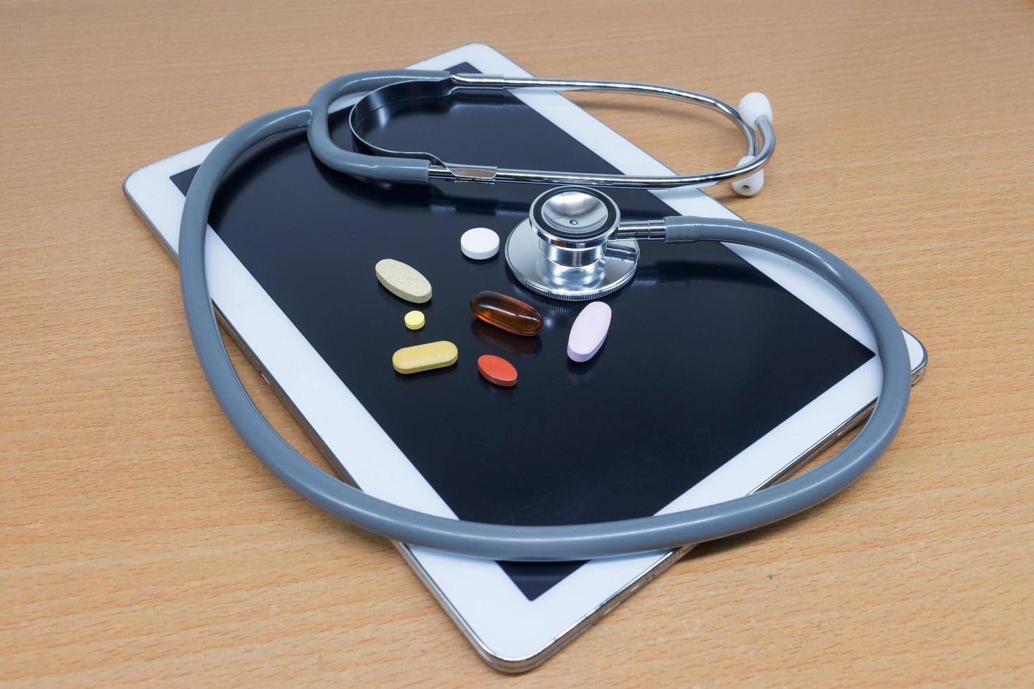 Tablet and stethoscopes on table photo