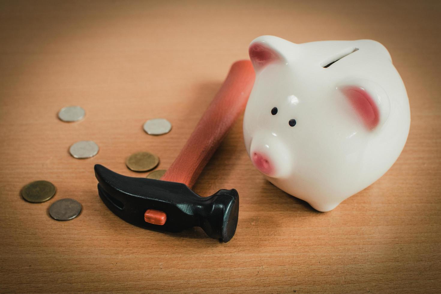 Little boy breaking a piggy bank photo