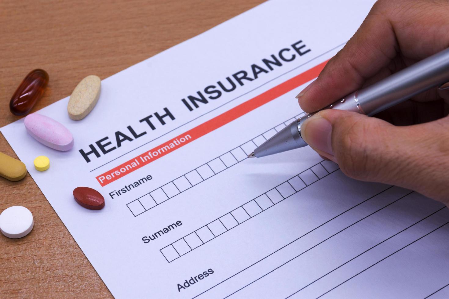 Health insurance paperwork, medicine, stethoscope. Health insurance claim concept. photo