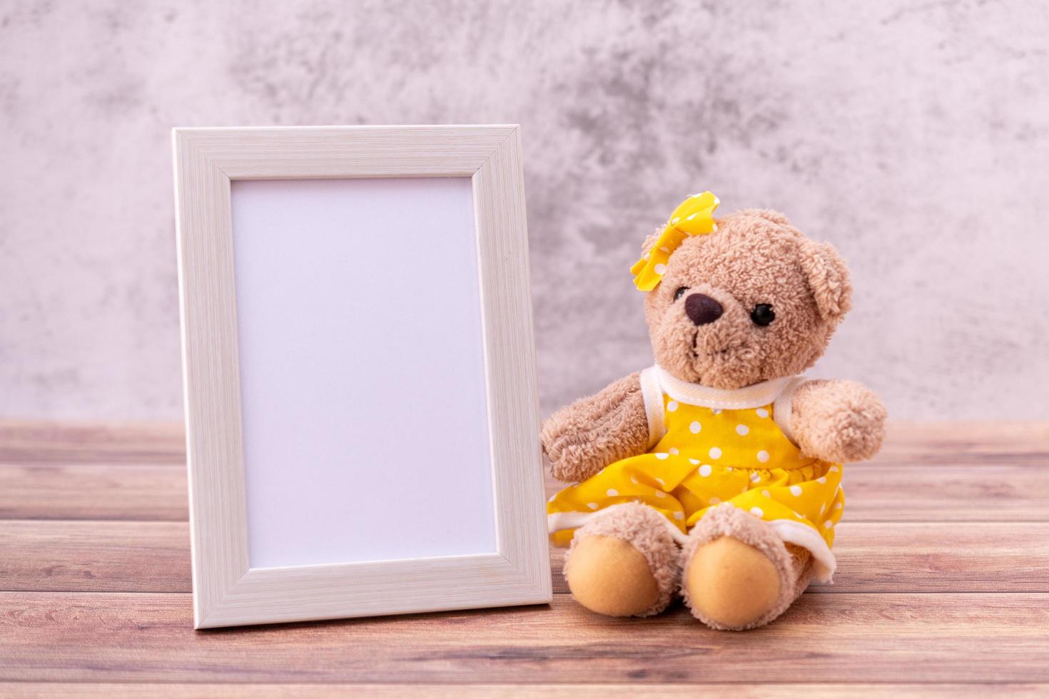 teddy bear with Picture frame on table wooden. Valentine's Day celebration photo